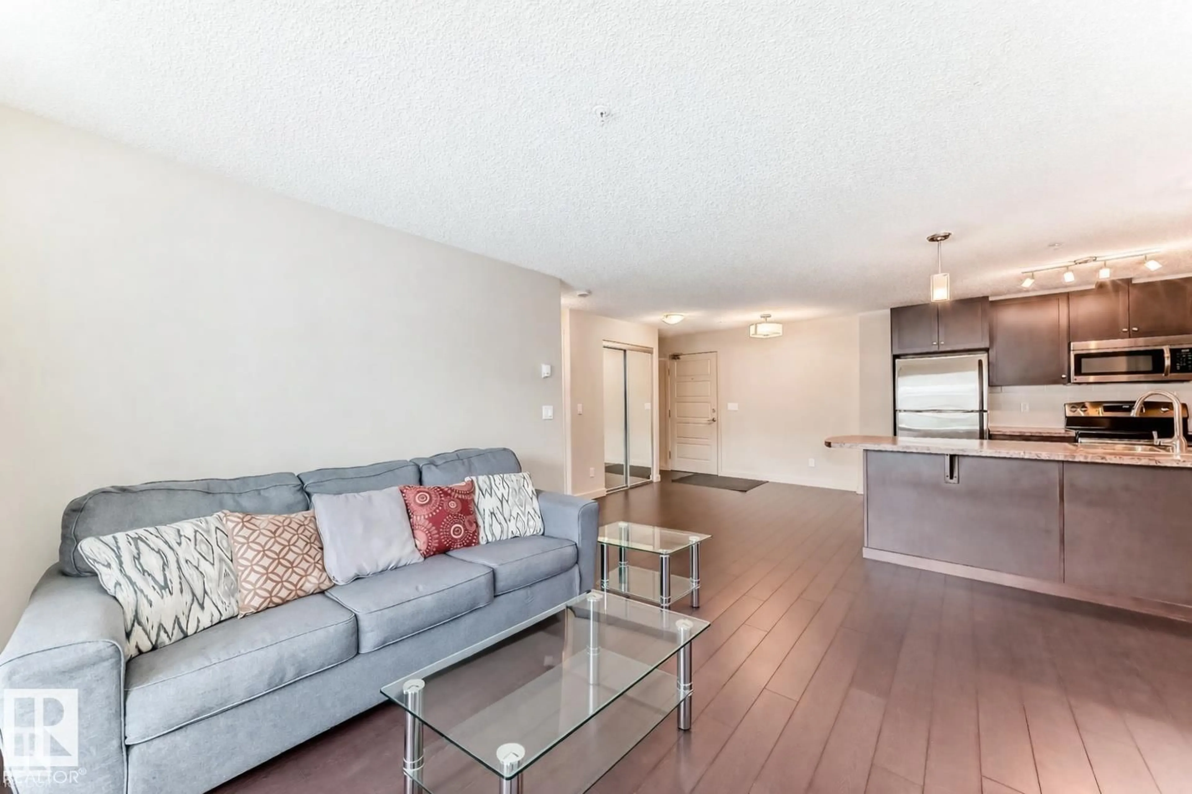 Living room with furniture, wood/laminate floor for 229 6076 SCHONSEE WY NW, Edmonton Alberta T5Z0K8