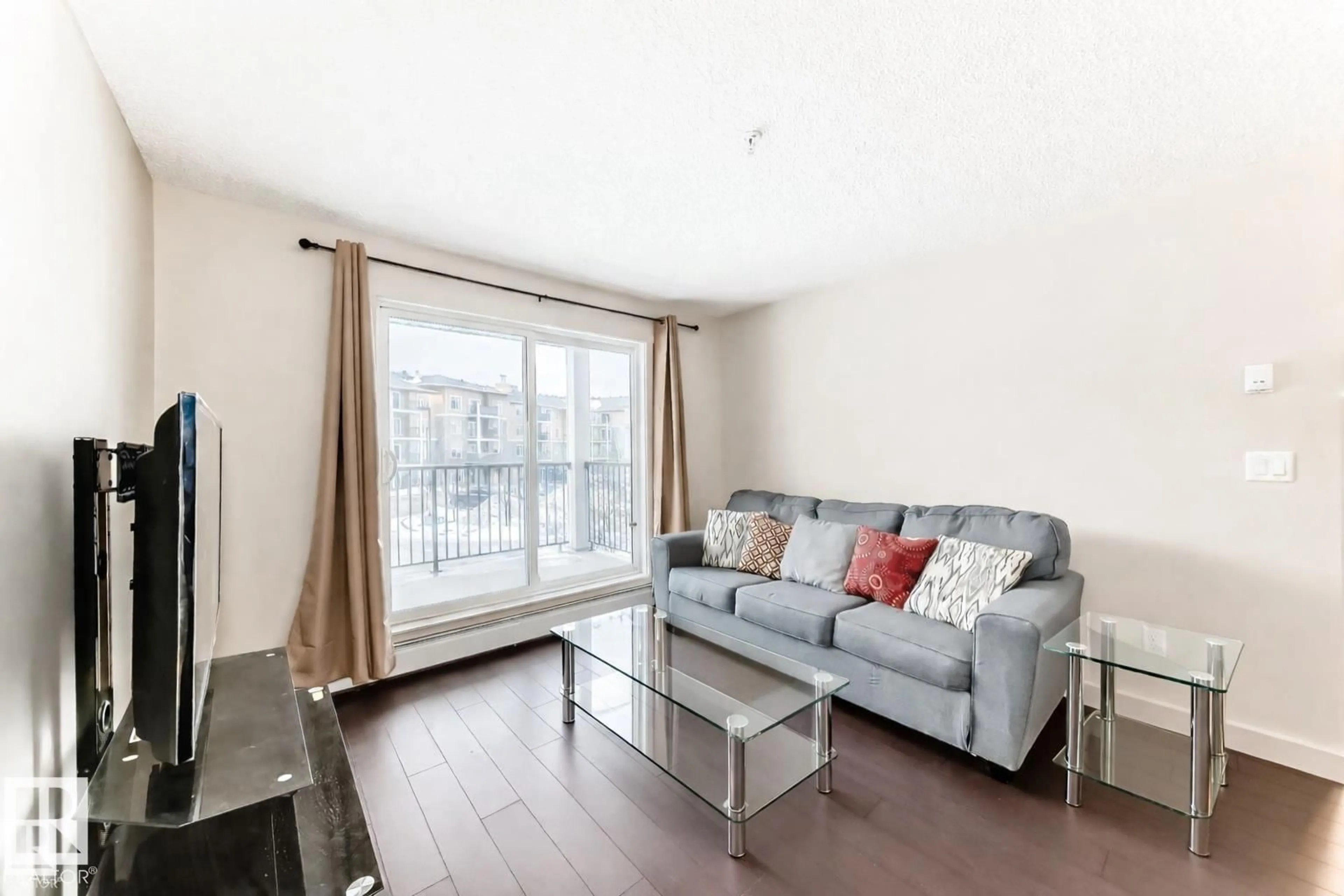 Living room with furniture, wood/laminate floor for 229 6076 SCHONSEE WY NW, Edmonton Alberta T5Z0K8