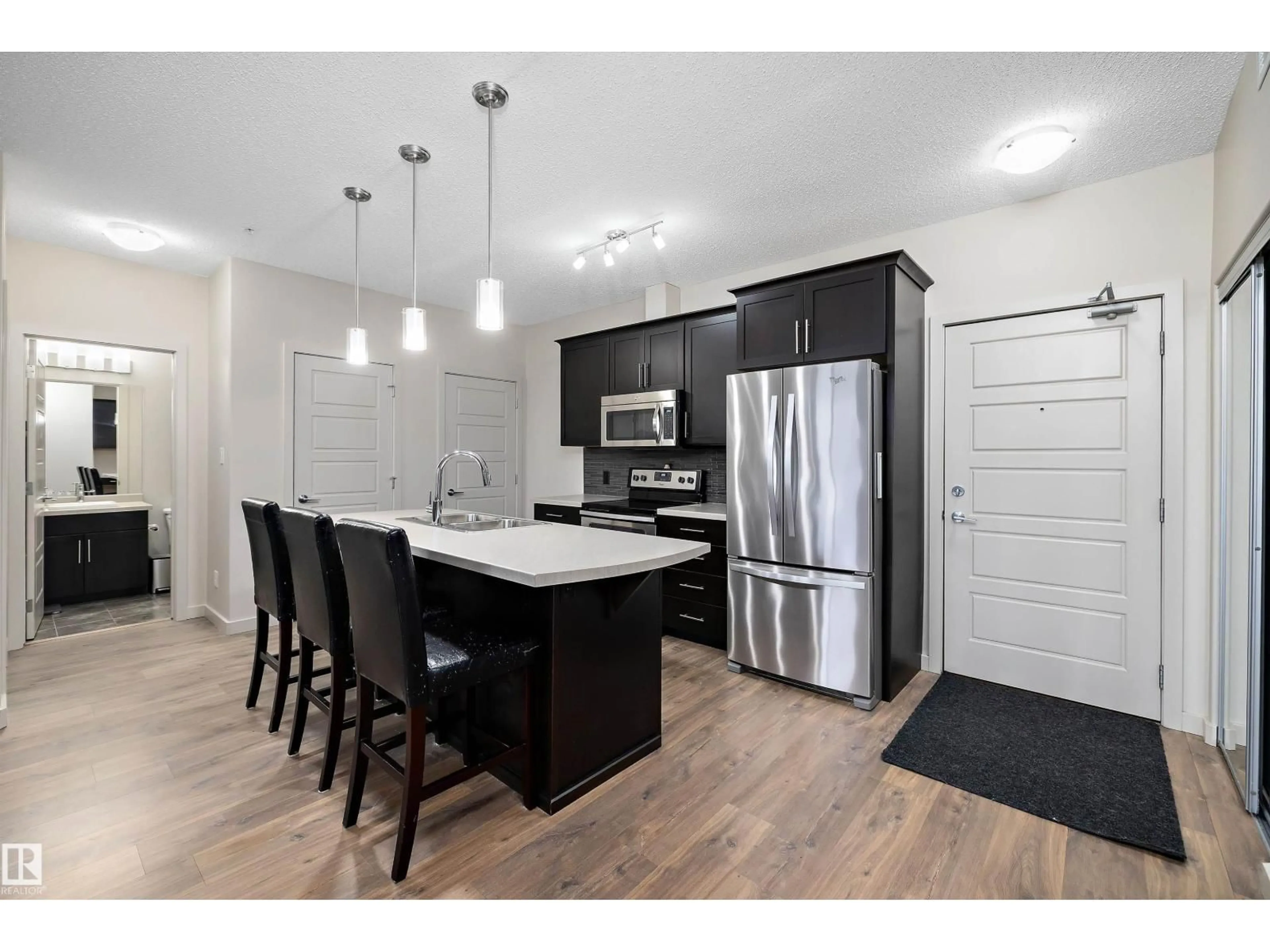 Open concept kitchen, wood/laminate floor for #214 - 1004 ROSENTHAL BV, Edmonton Alberta T5T7C6
