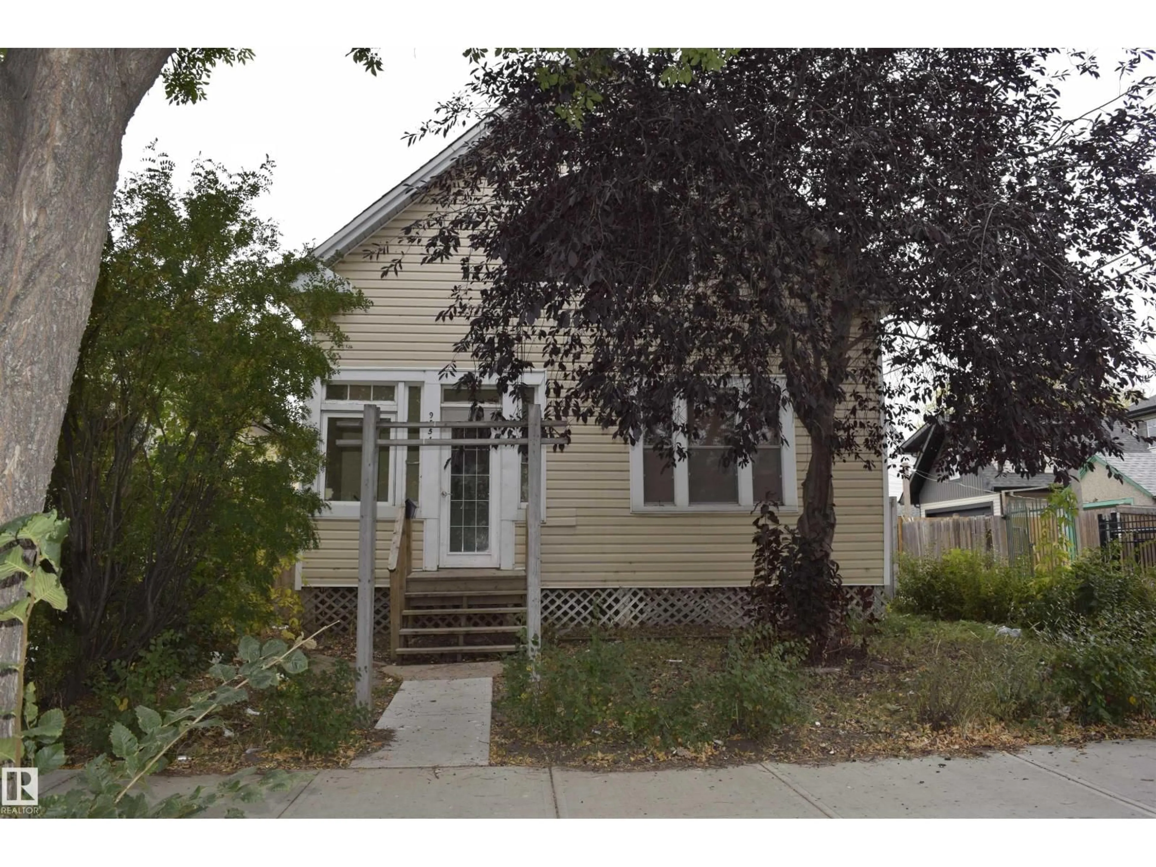 Home with vinyl exterior material, street for 9551 106A AV, Edmonton Alberta T5H0S9