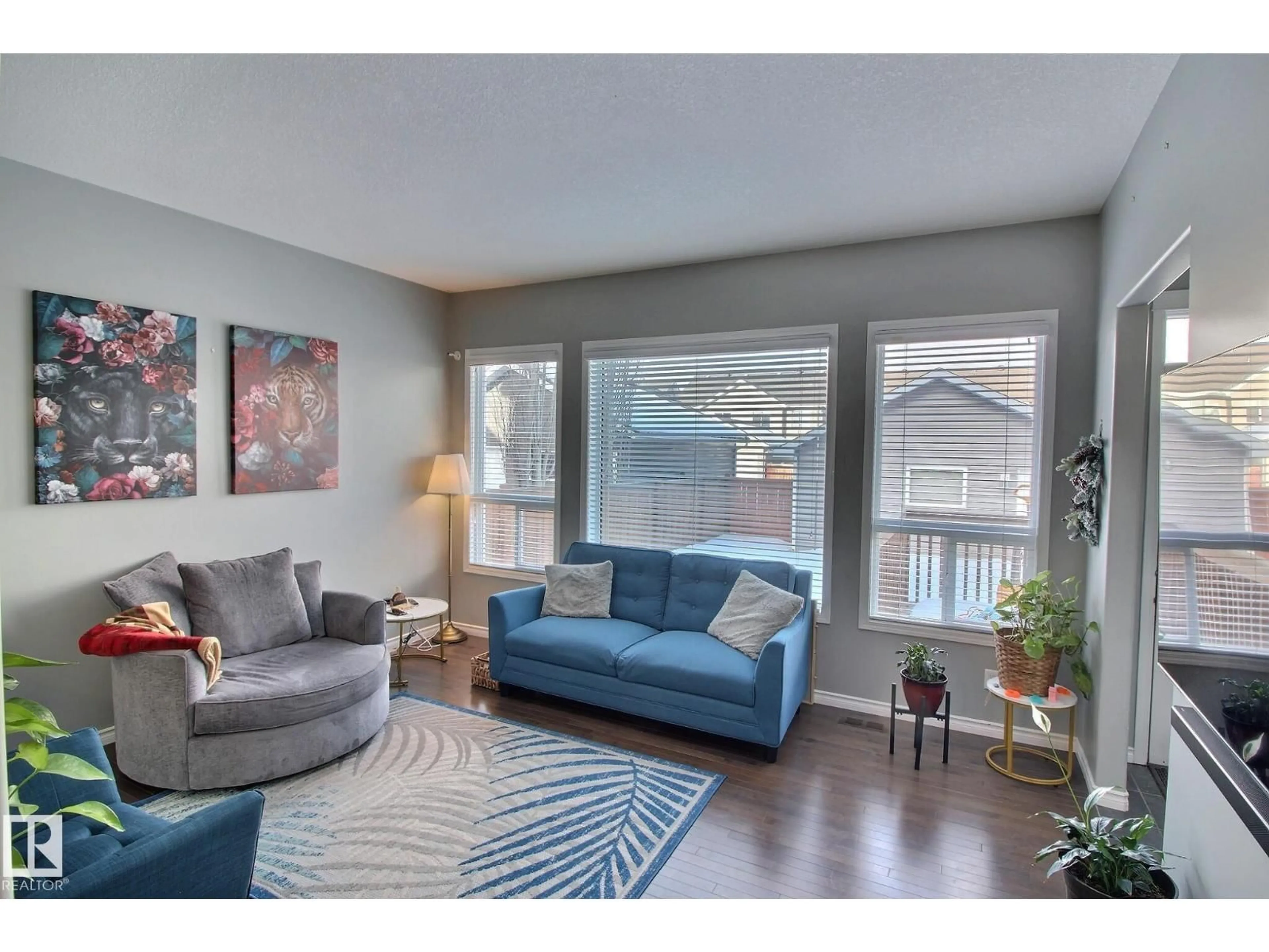 Living room with furniture, wood/laminate floor for 6912 22 AV, Edmonton Alberta T6X0V4