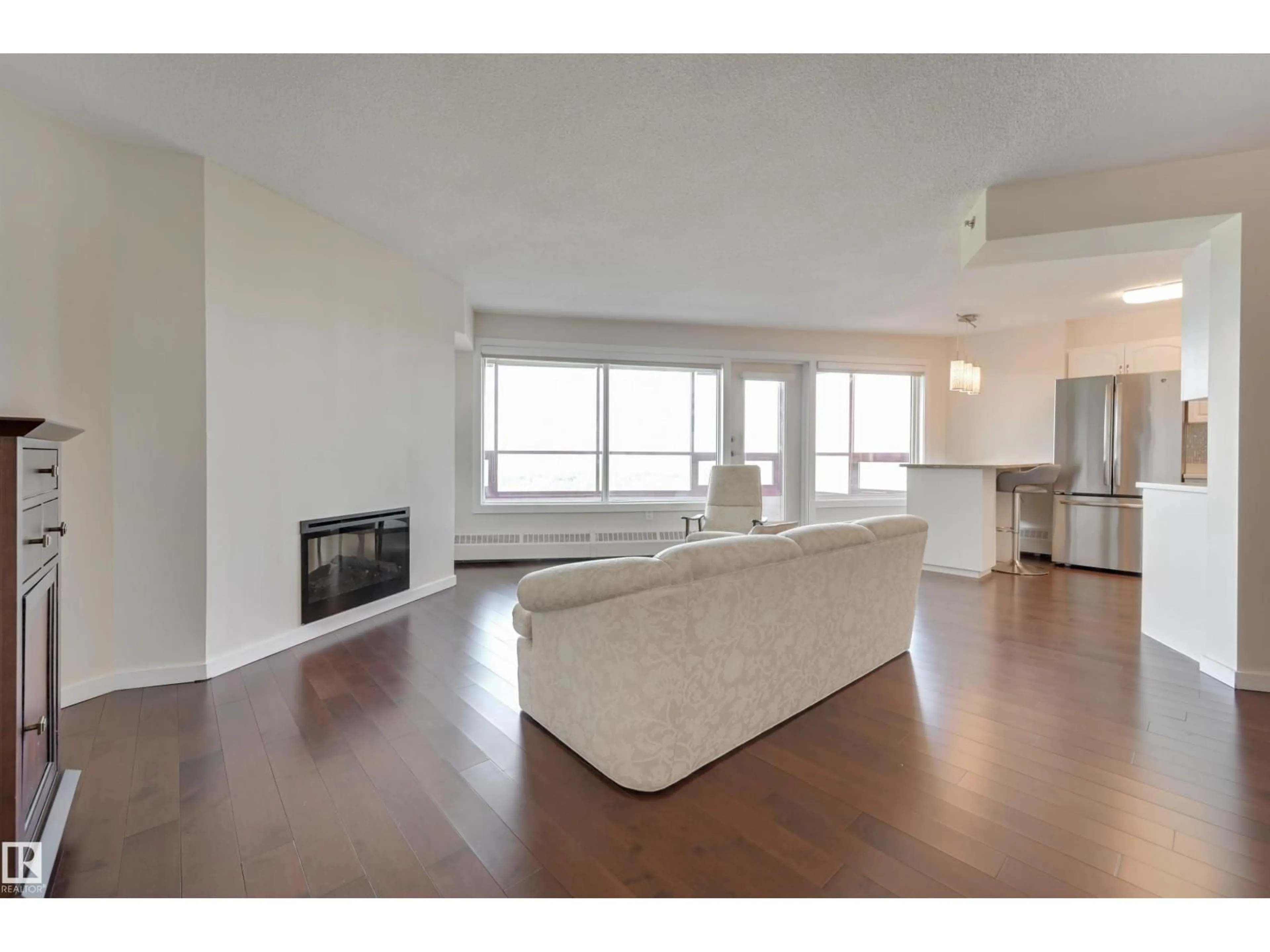 Living room with furniture, wood/laminate floor for #1003 - 12319 JASPER AV, Edmonton Alberta T5N4A7