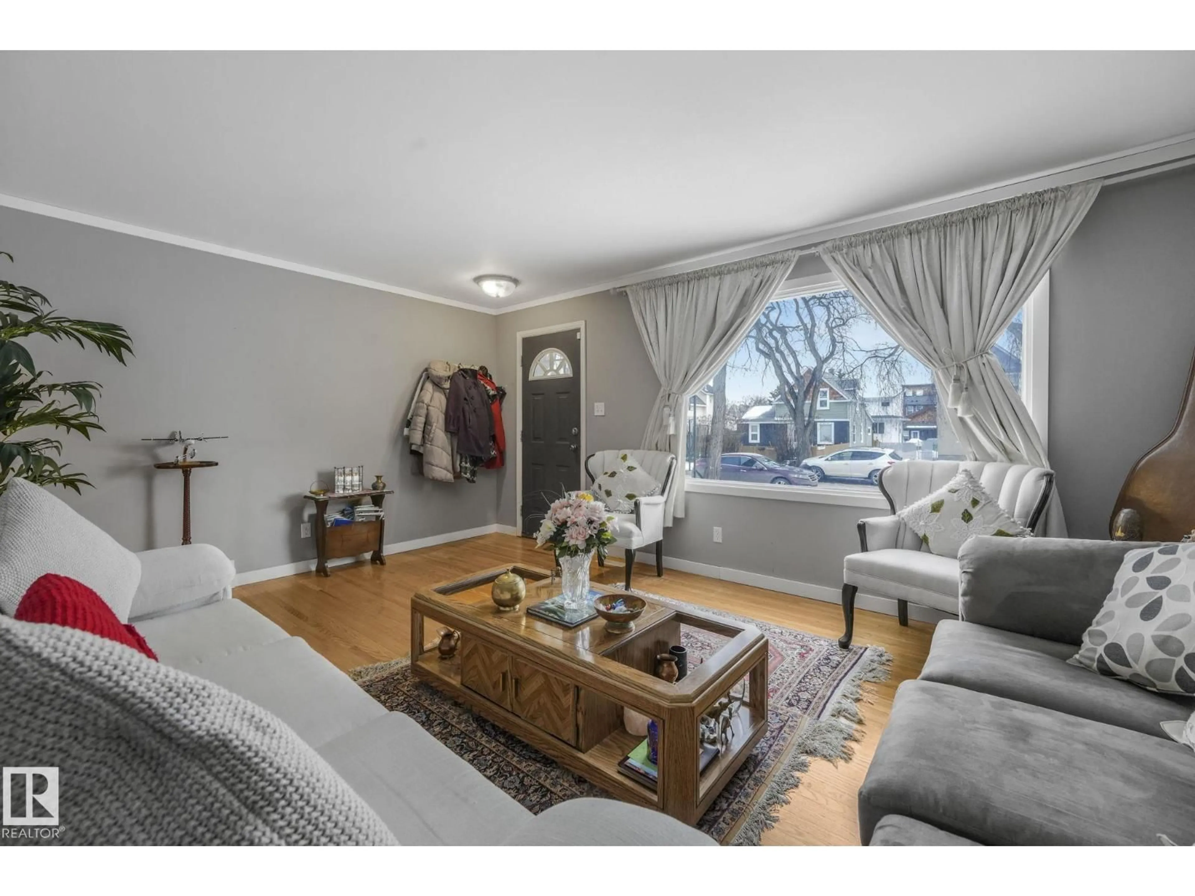 Living room with furniture, wood/laminate floor for 12032 55 ST, Edmonton Alberta T5W2R2