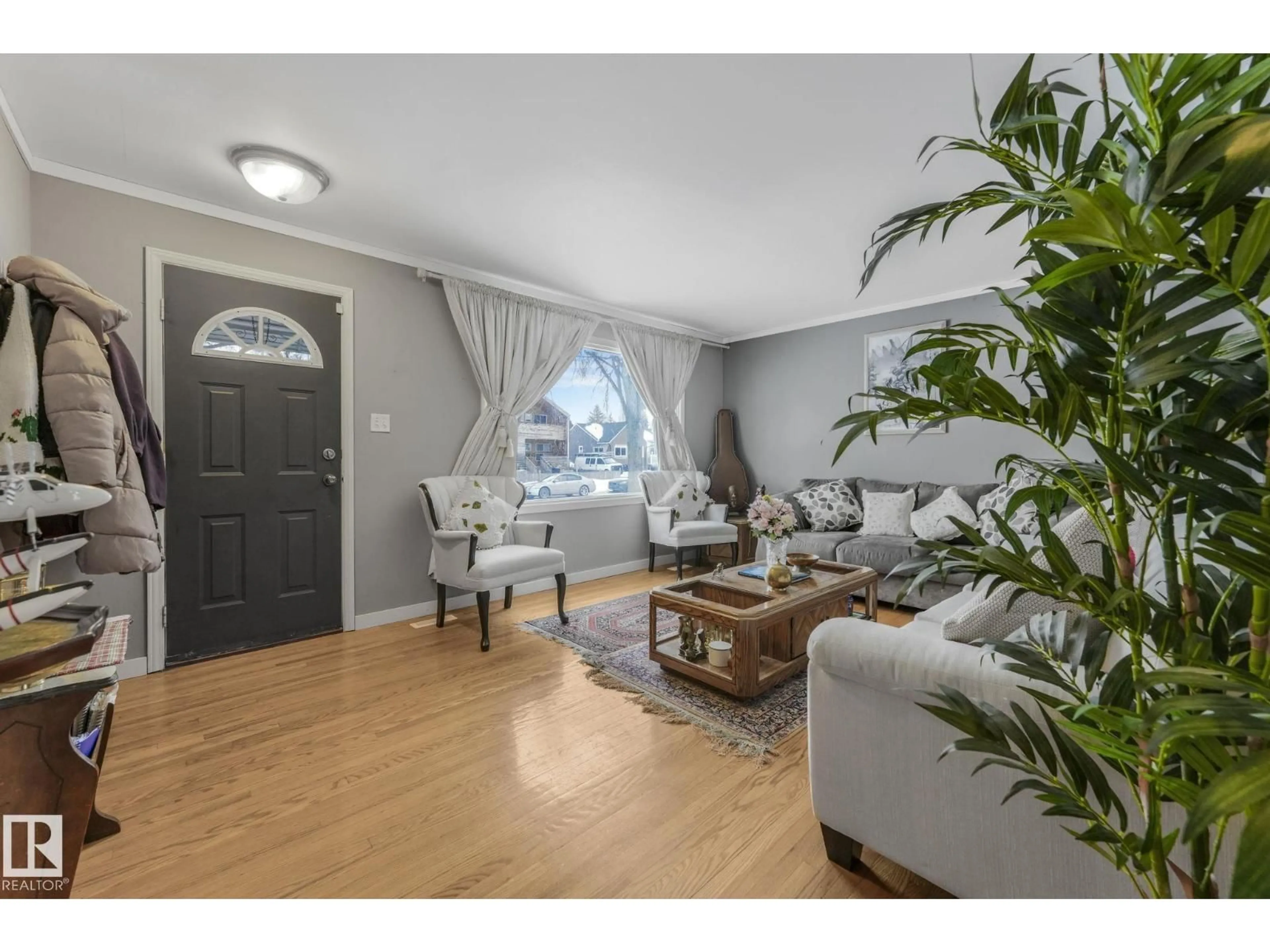 Living room with furniture, wood/laminate floor for 12032 55 ST, Edmonton Alberta T5W2R2