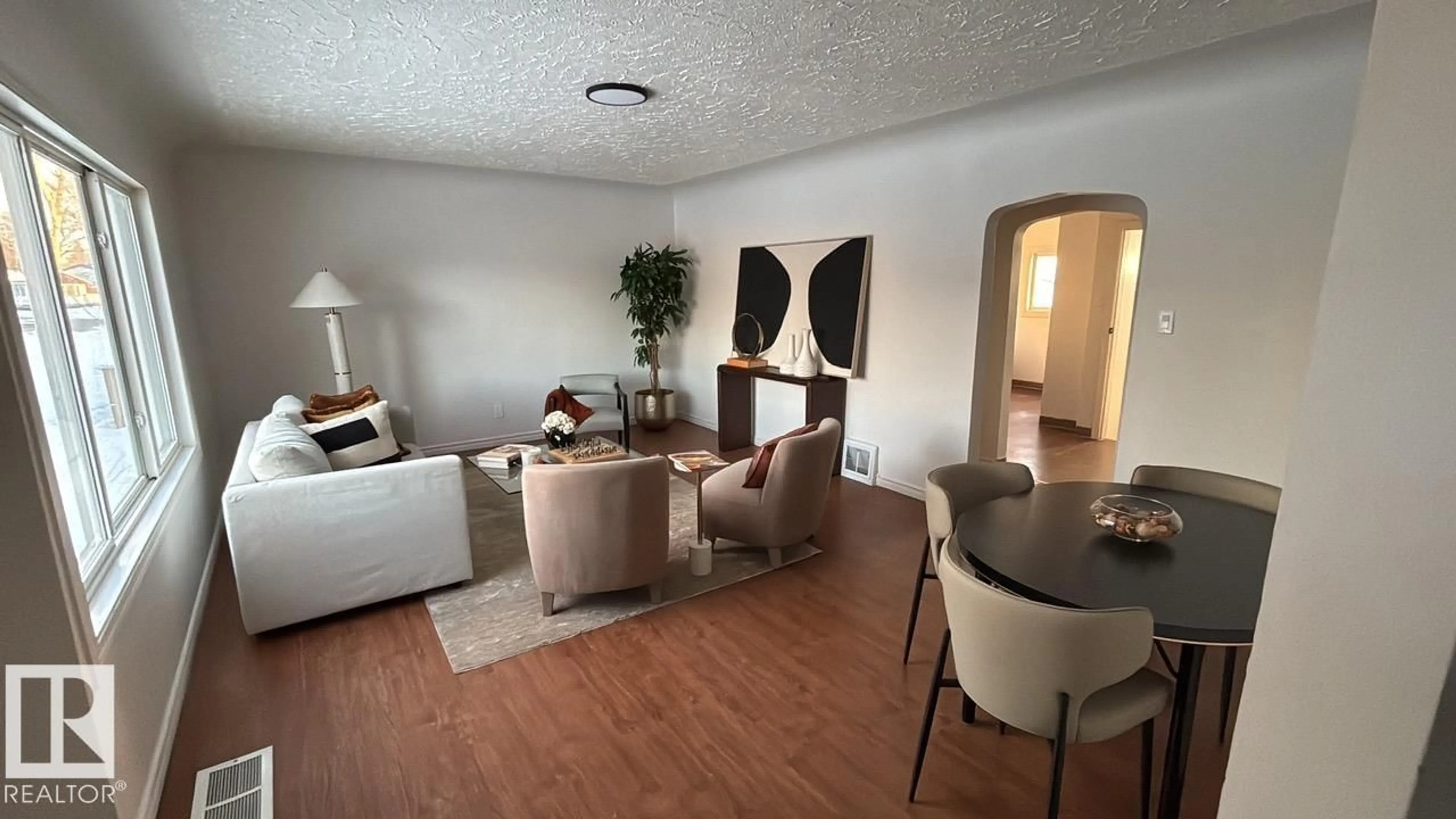 Living room with furniture, wood/laminate floor for 13023 SHERBROOKE AV, Edmonton Alberta T5L4E6
