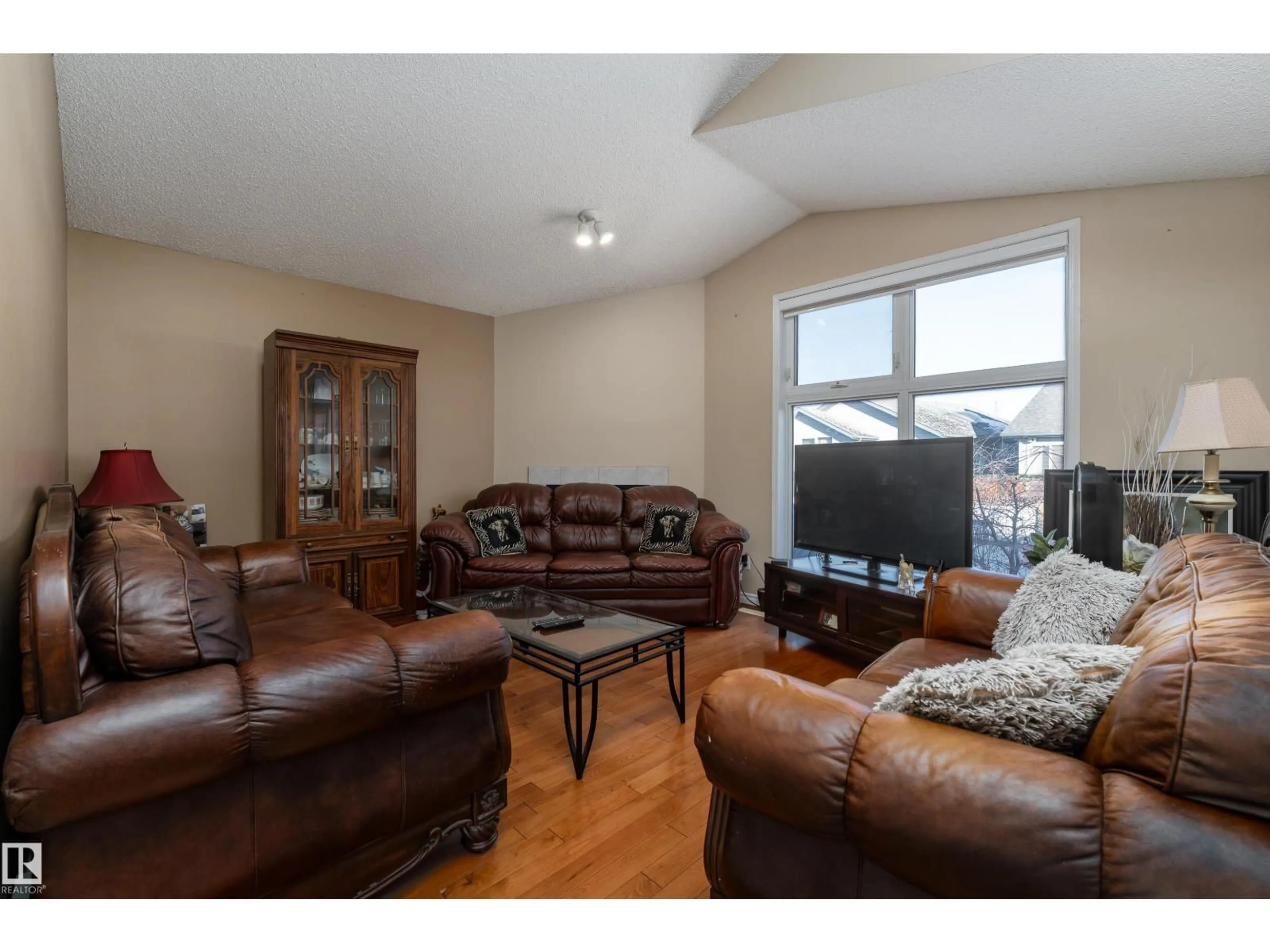 Living room with furniture, wood/laminate floor for 3769 23 ST, Edmonton Alberta T6T1N8