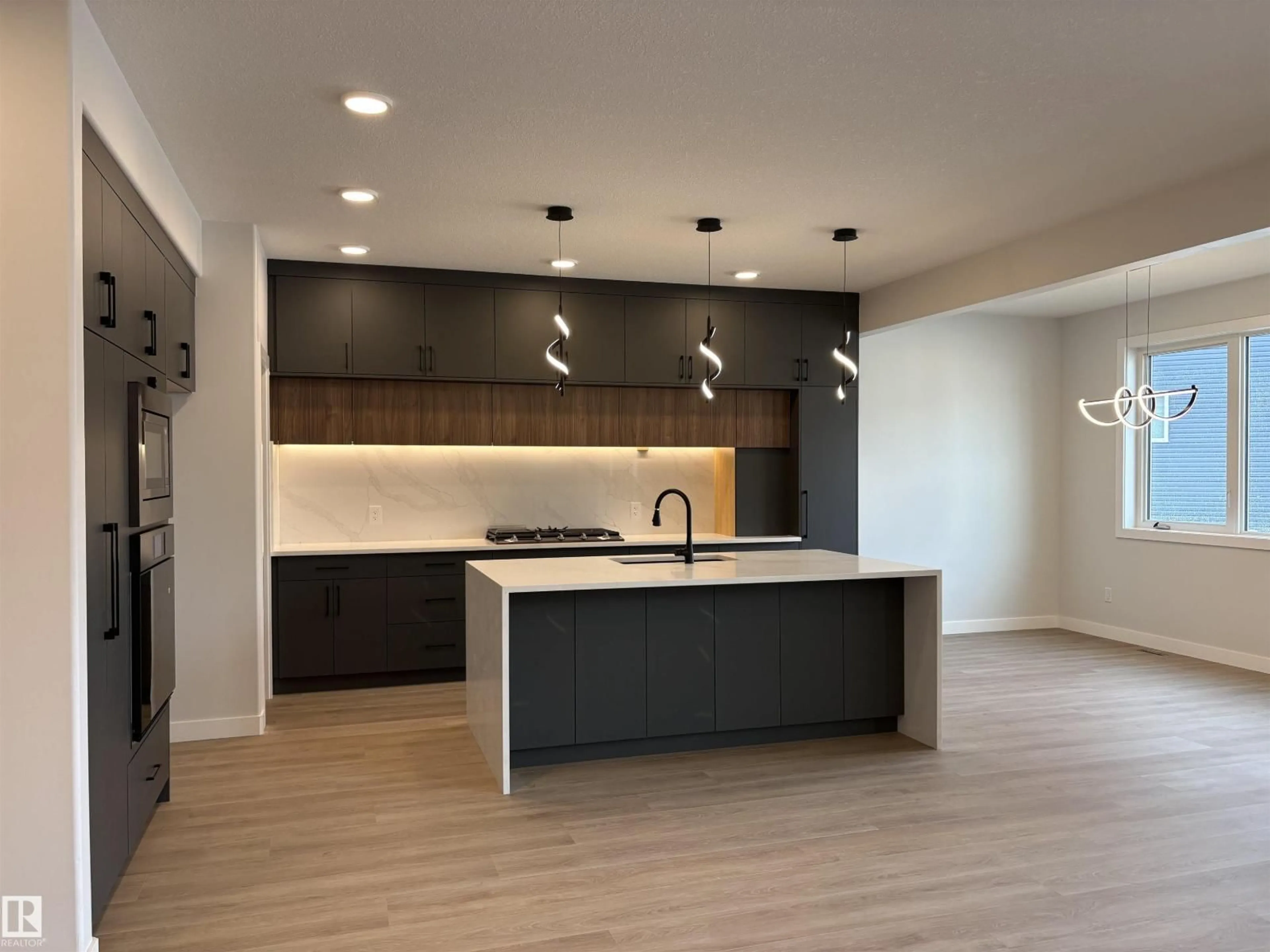 Open concept kitchen, wood/laminate floor for NW - 1039 151 AVE, Edmonton Alberta T5Y4C8