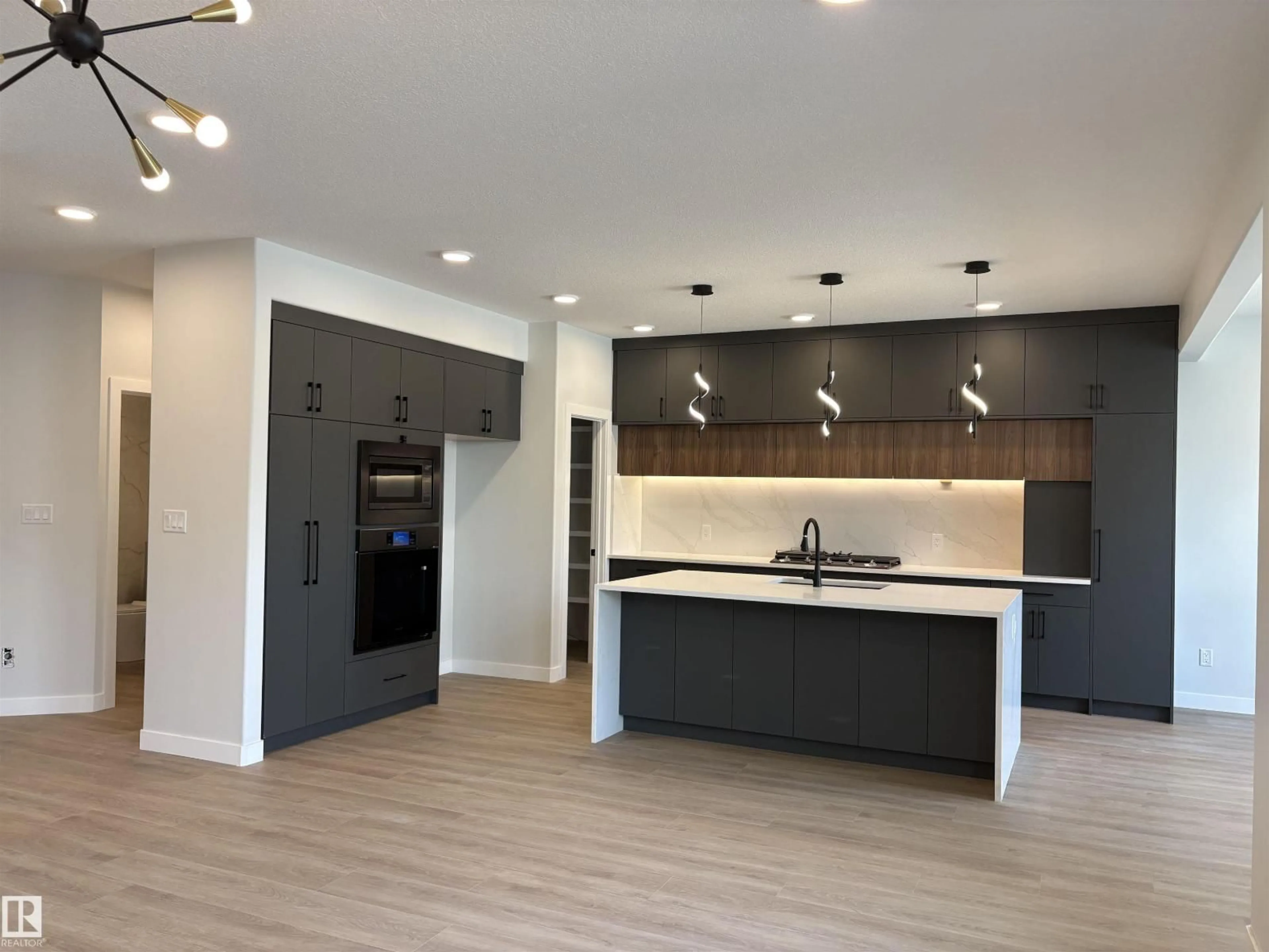 Open concept kitchen, wood/laminate floor for NW - 1039 151 AVE, Edmonton Alberta T5Y4C8