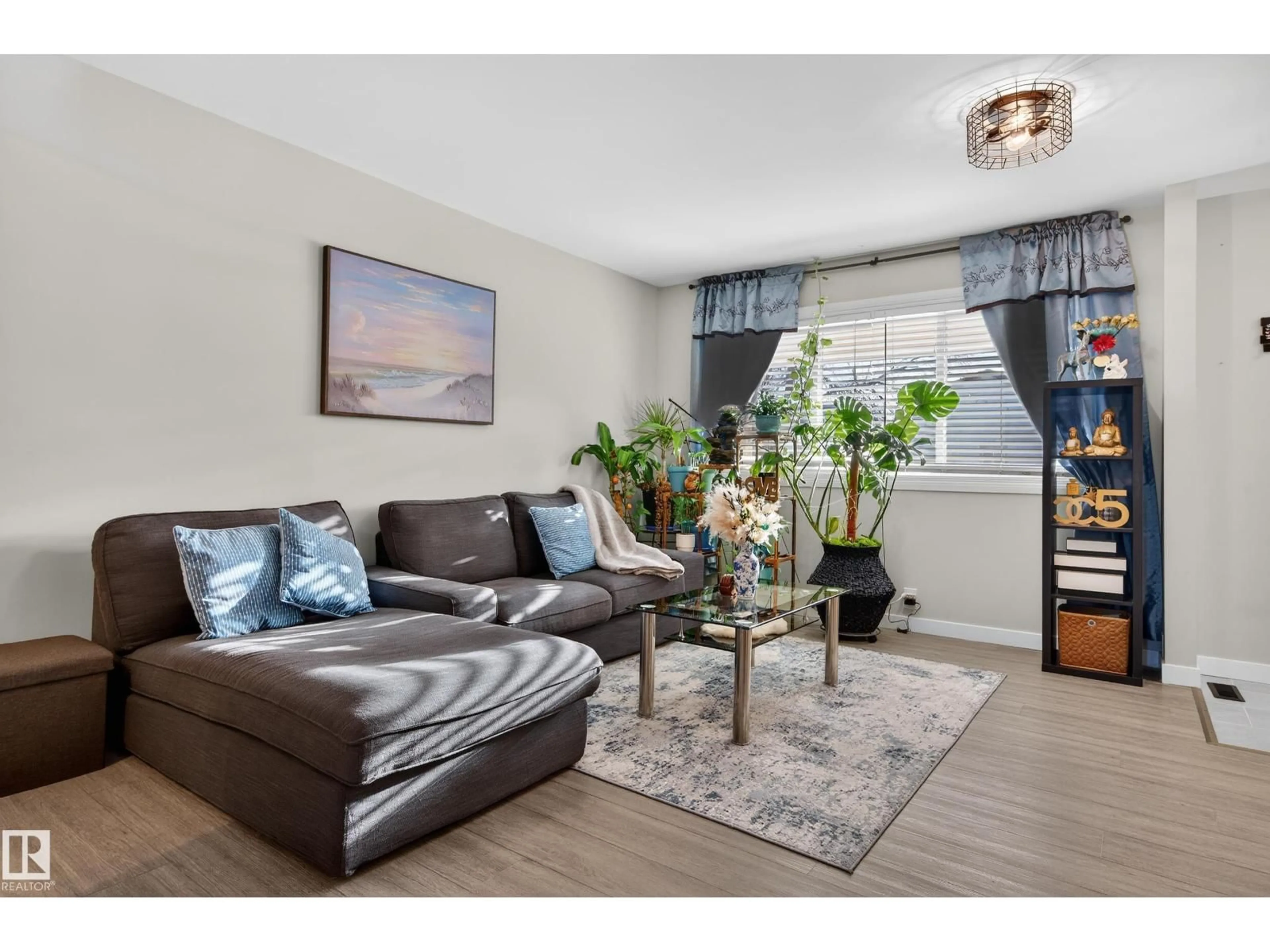 Living room with furniture, wood/laminate floor for 4755 35 AV, Edmonton Alberta T6L3P8