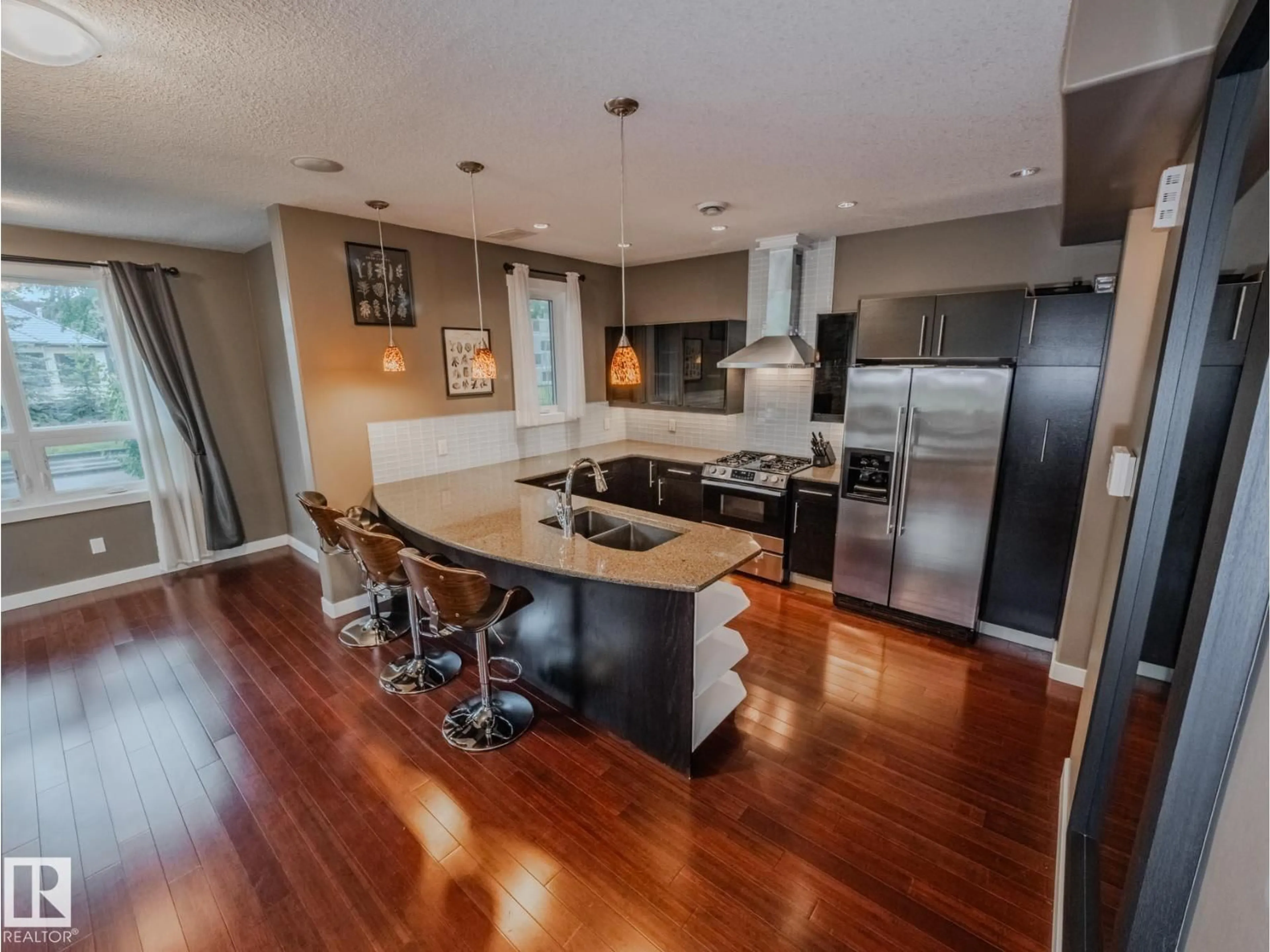 Open concept kitchen, wood/laminate floor for 8306 108 ST, Edmonton Alberta T6E2J1