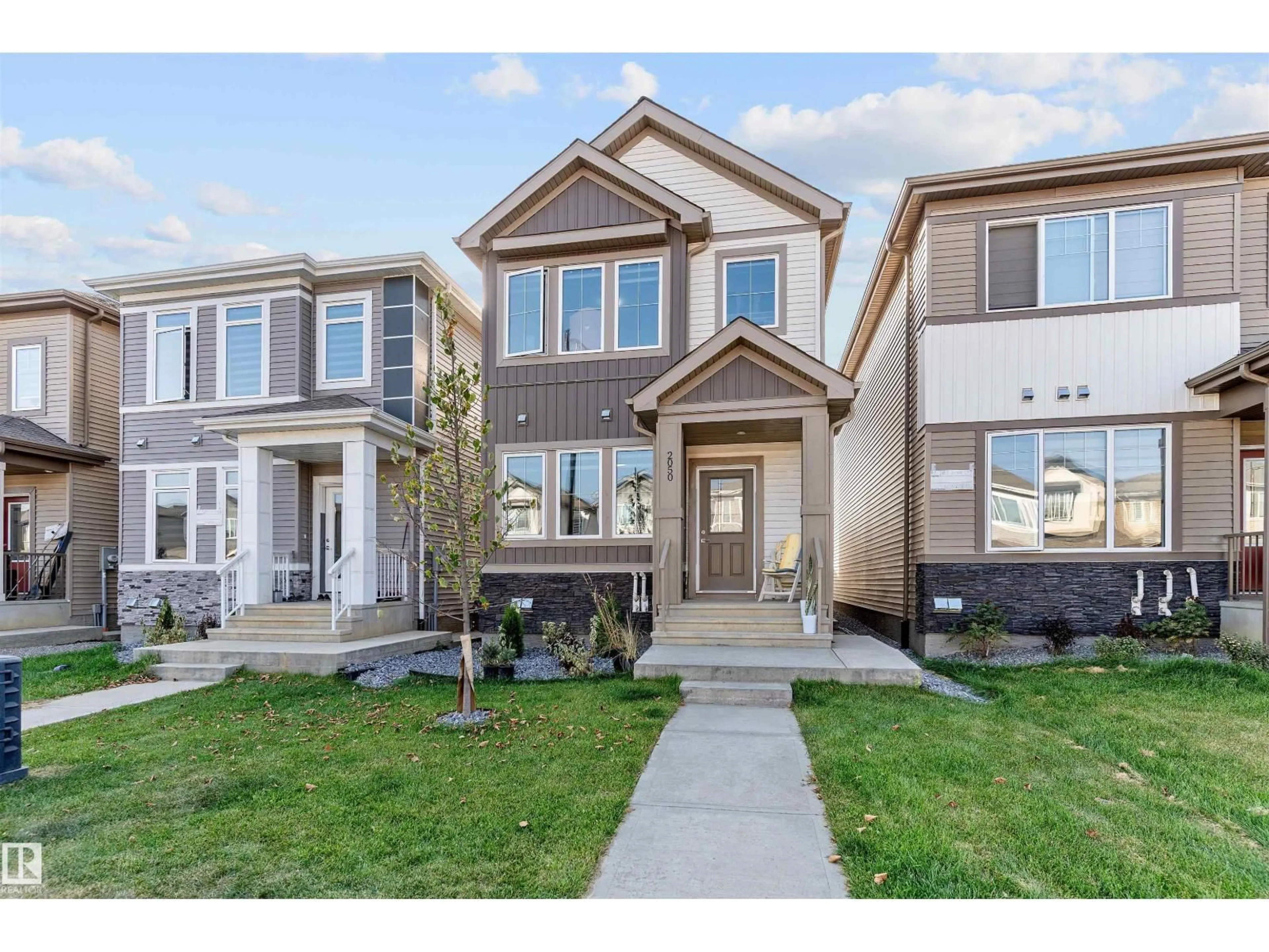 Home with vinyl exterior material, street for NW - 2050 209A ST, Edmonton Alberta T6M3C8