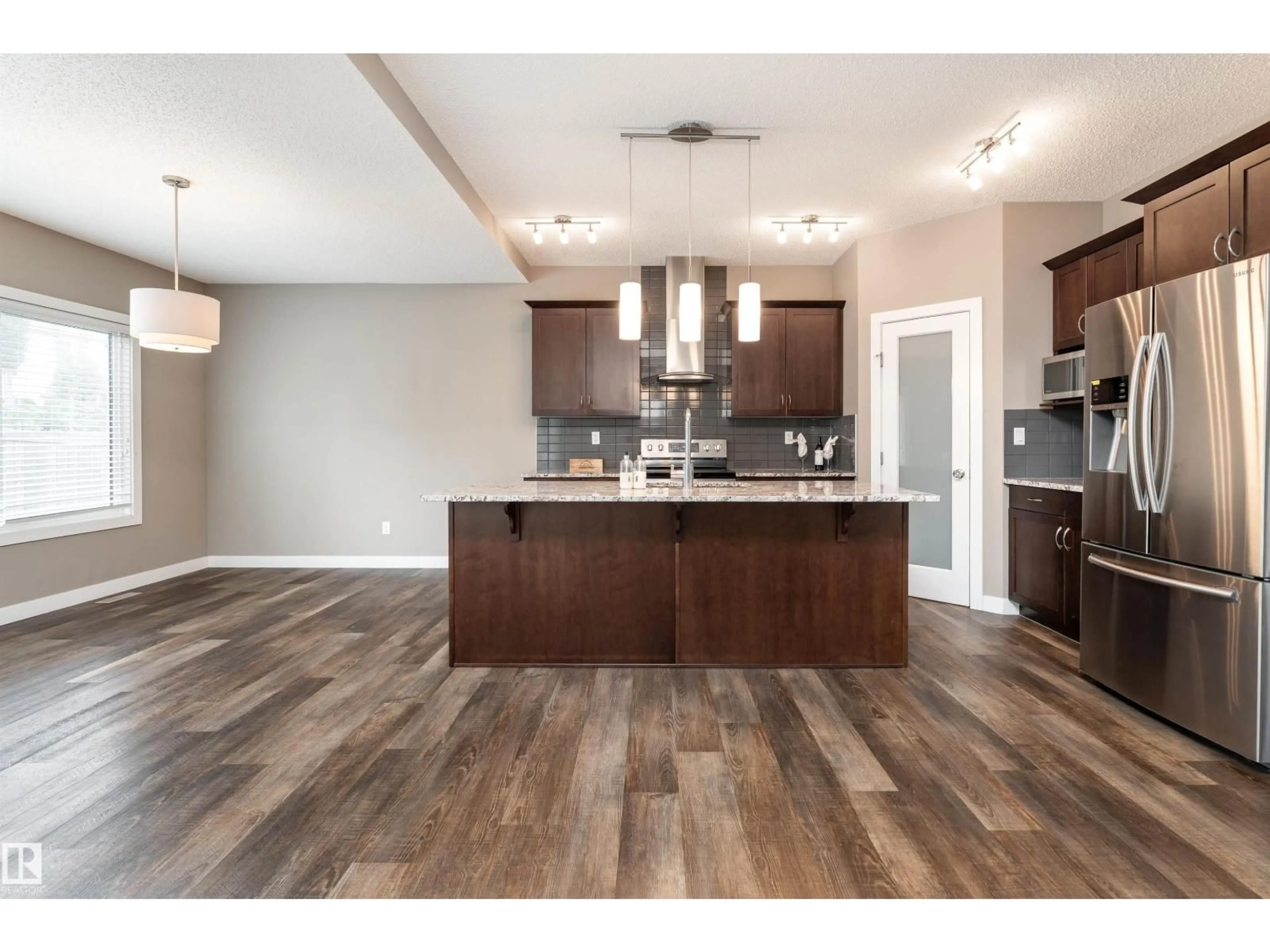 Open concept kitchen, wood/laminate floor for 2211 CALHOUN LI SW, Edmonton Alberta T6W3E1