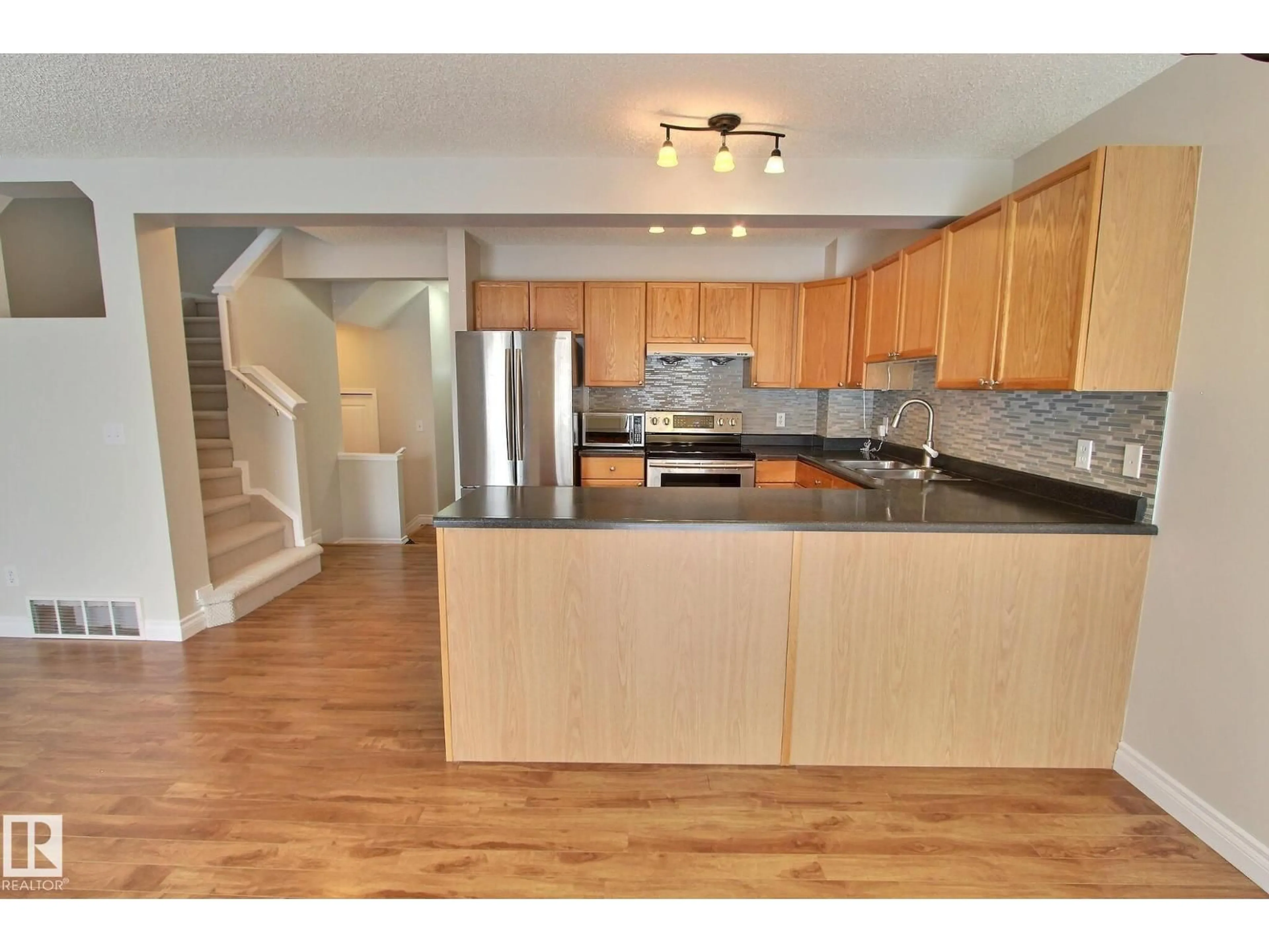 Open concept kitchen, wood/laminate floor for NW - 16127 132 ST, Edmonton Alberta T6V1N7