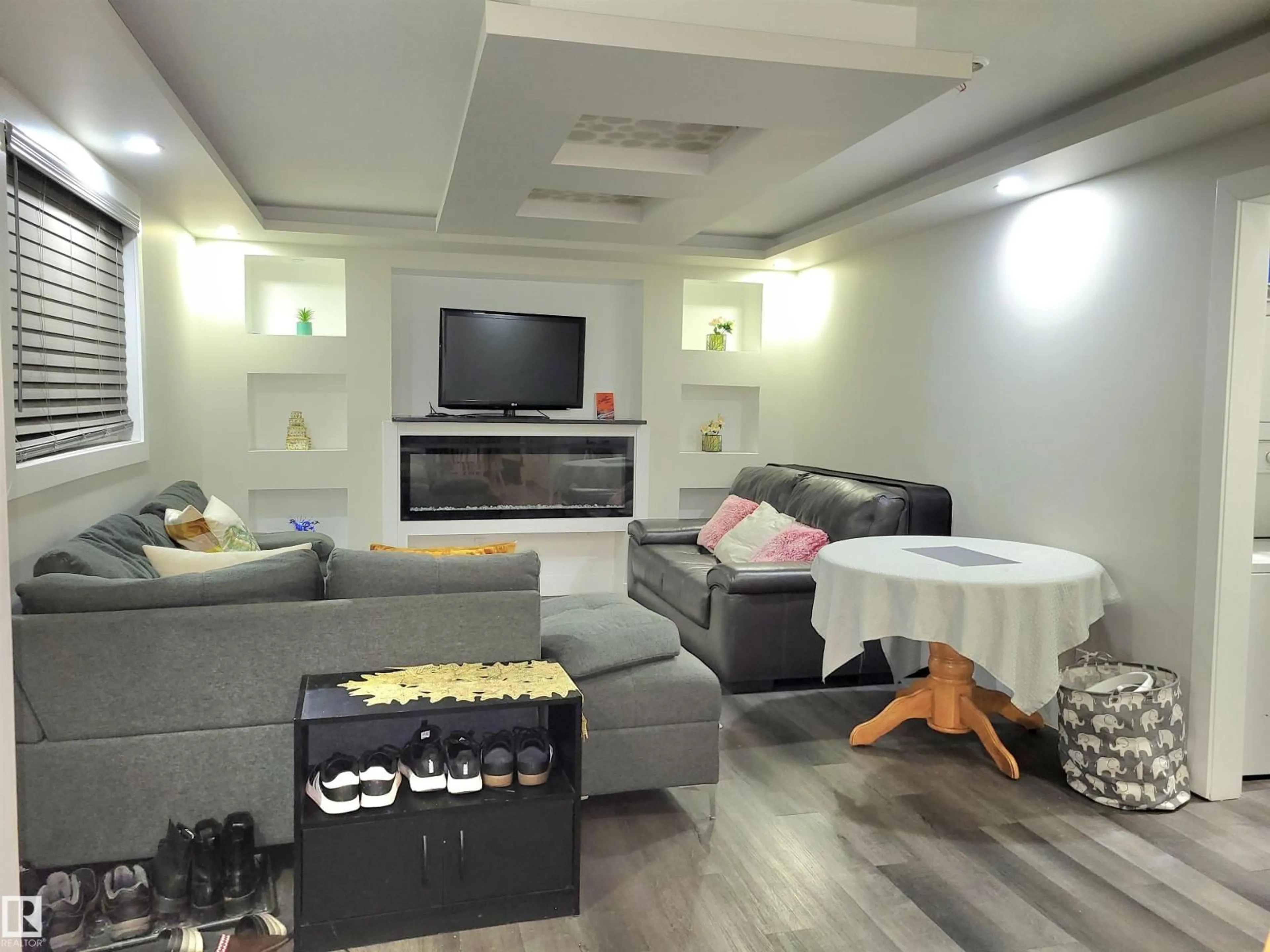 Living room with furniture, wood/laminate floor for NW - 9131 83 AV, Edmonton Alberta T6C1B6