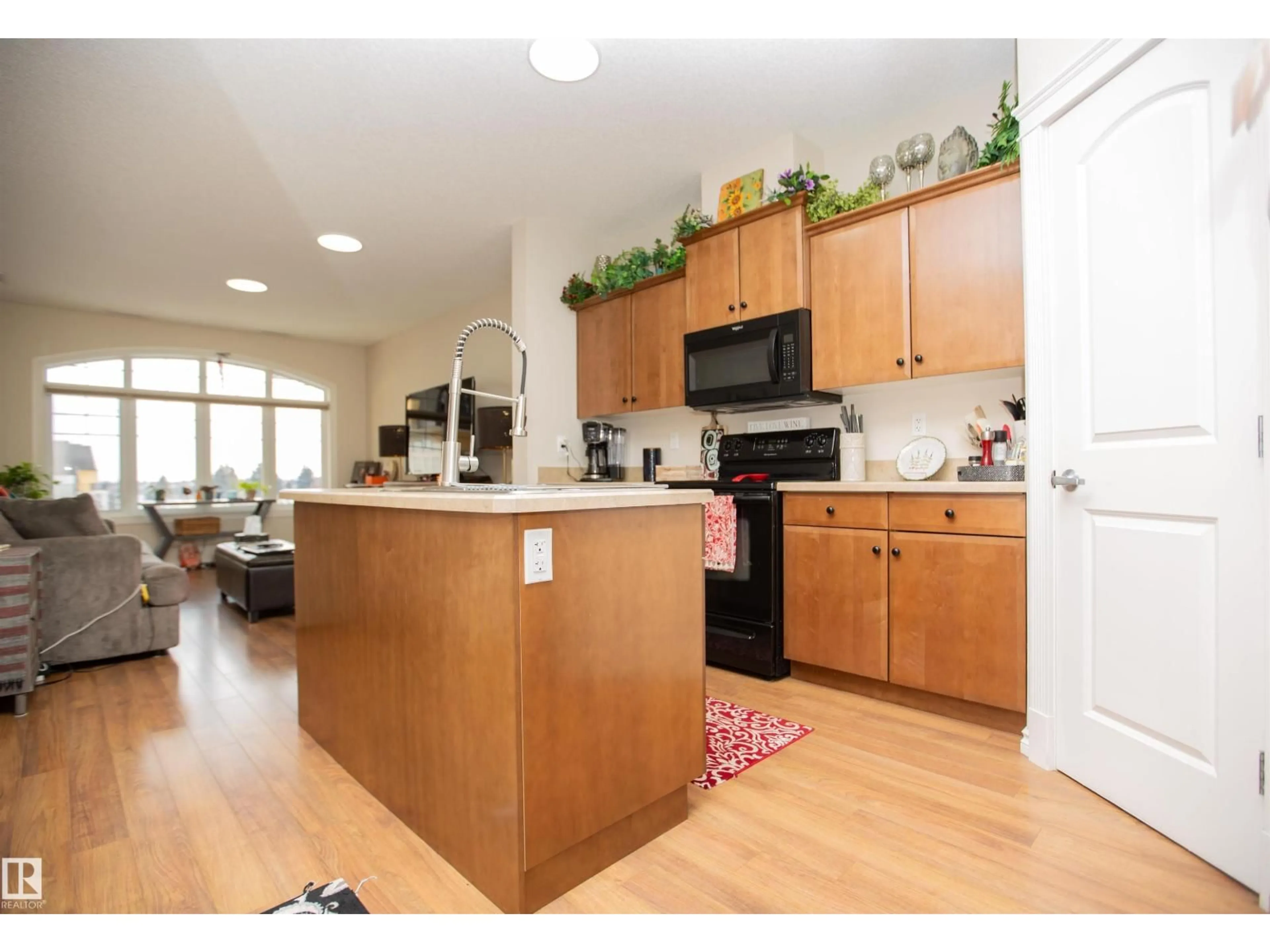 Open concept kitchen, wood/laminate floor for #404 - 9820 165 ST NW, Edmonton Alberta T5P0N3