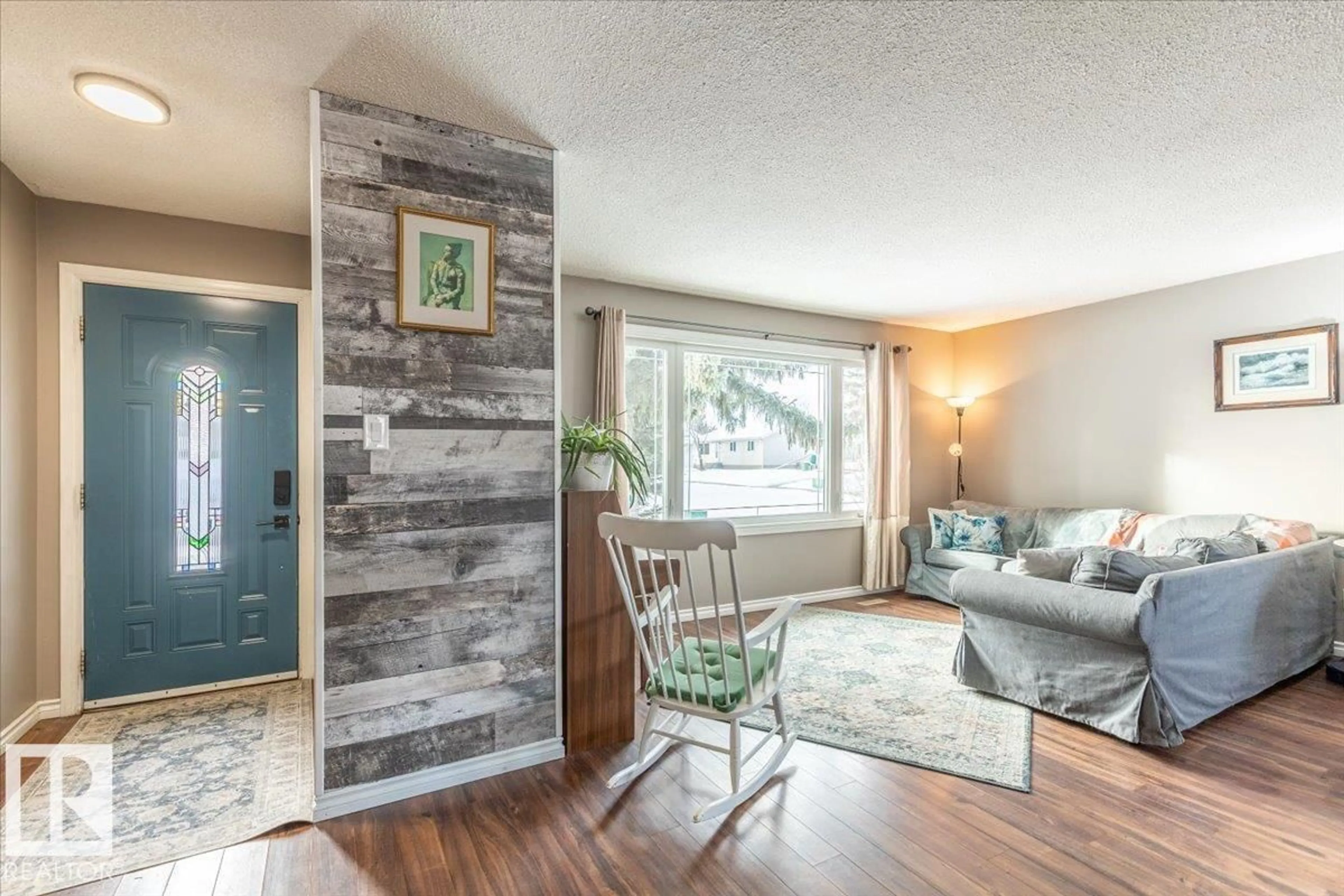 Living room with furniture, wood/laminate floor for 146 MAPLE CR, Wetaskiwin Alberta T9A2E5