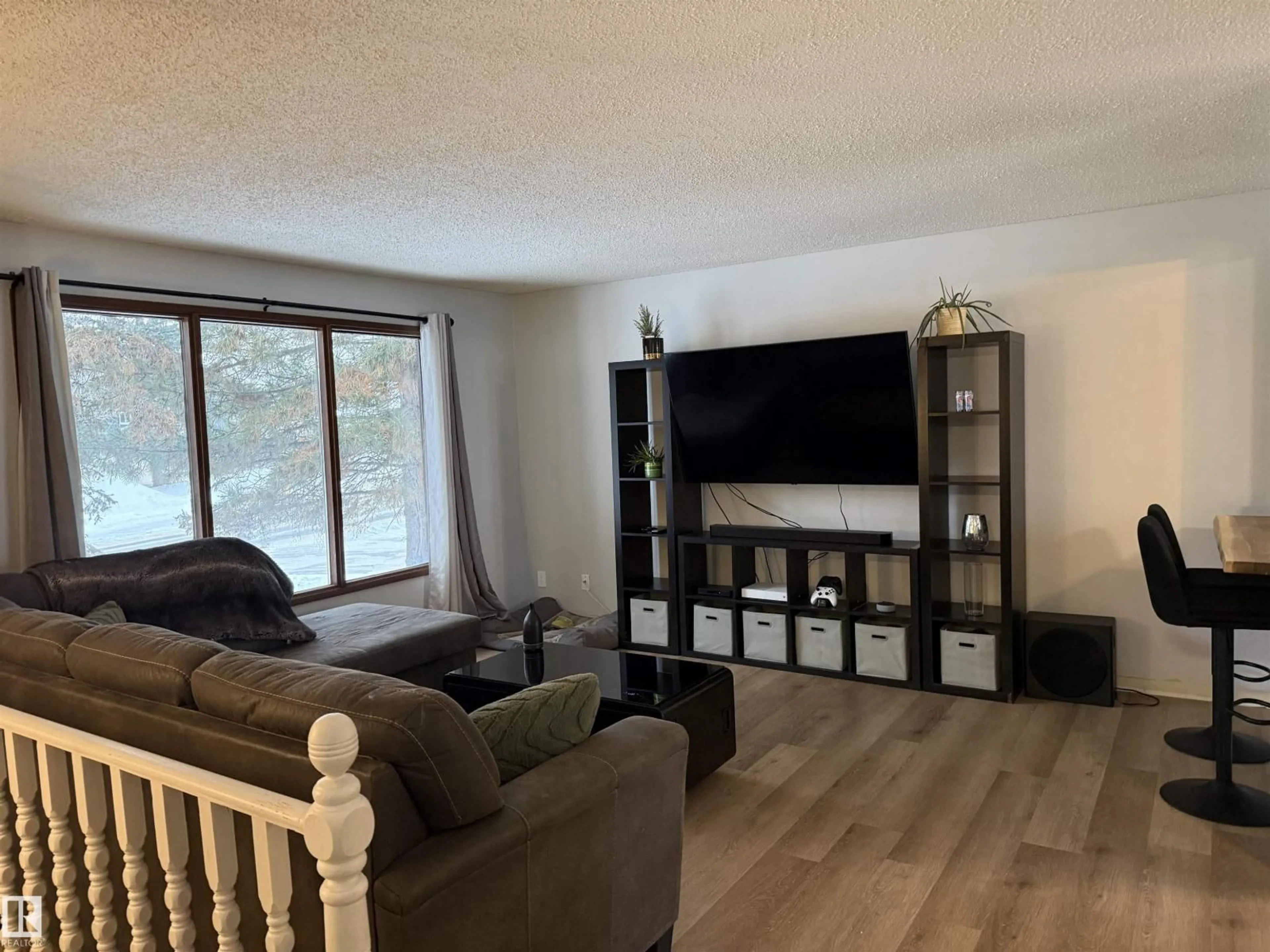 Living room with furniture, wood/laminate floor for 17115 100 ST, Edmonton Alberta T5X3G7