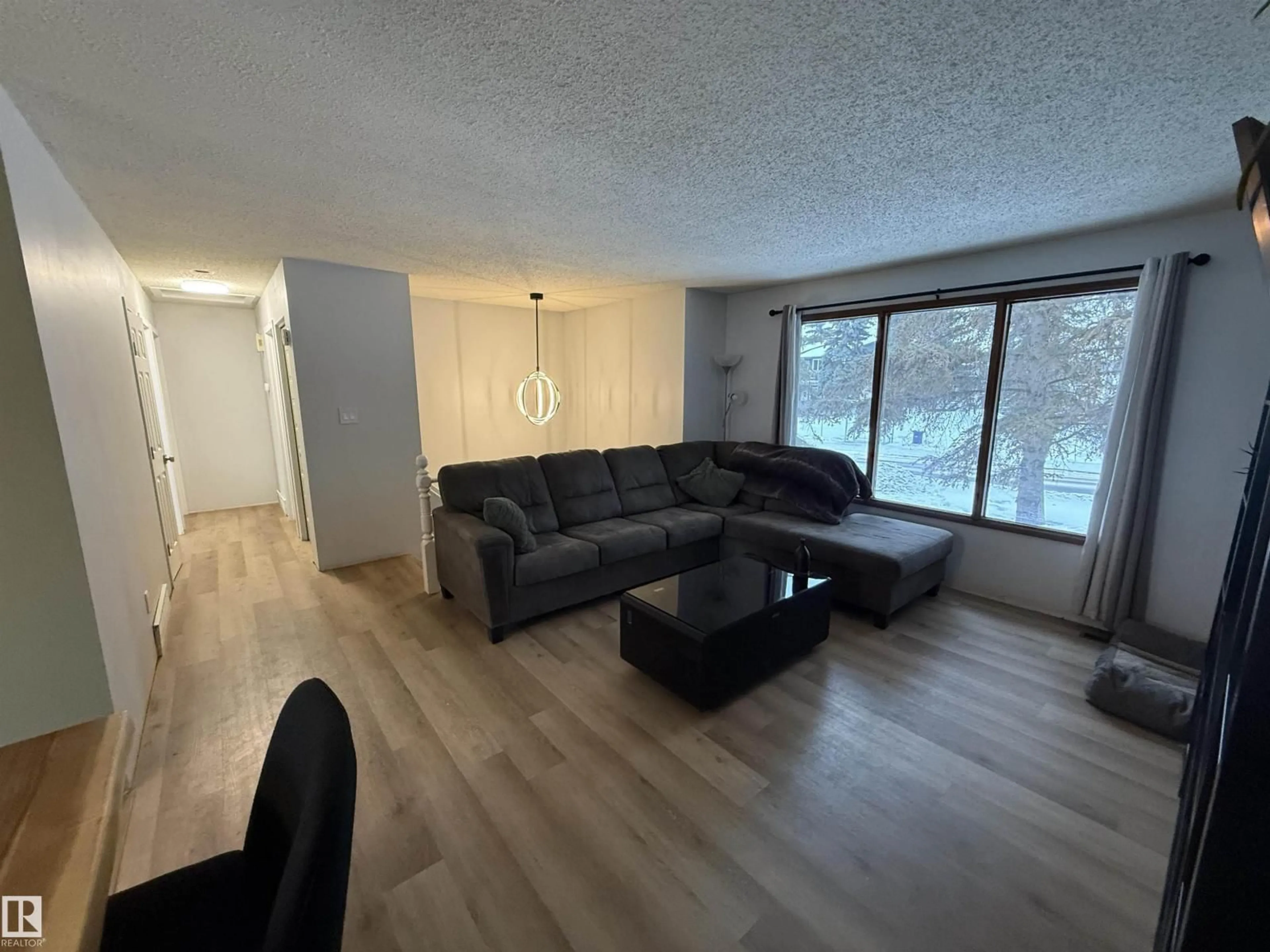 Living room with furniture, wood/laminate floor for 17115 100 ST, Edmonton Alberta T5X3G7