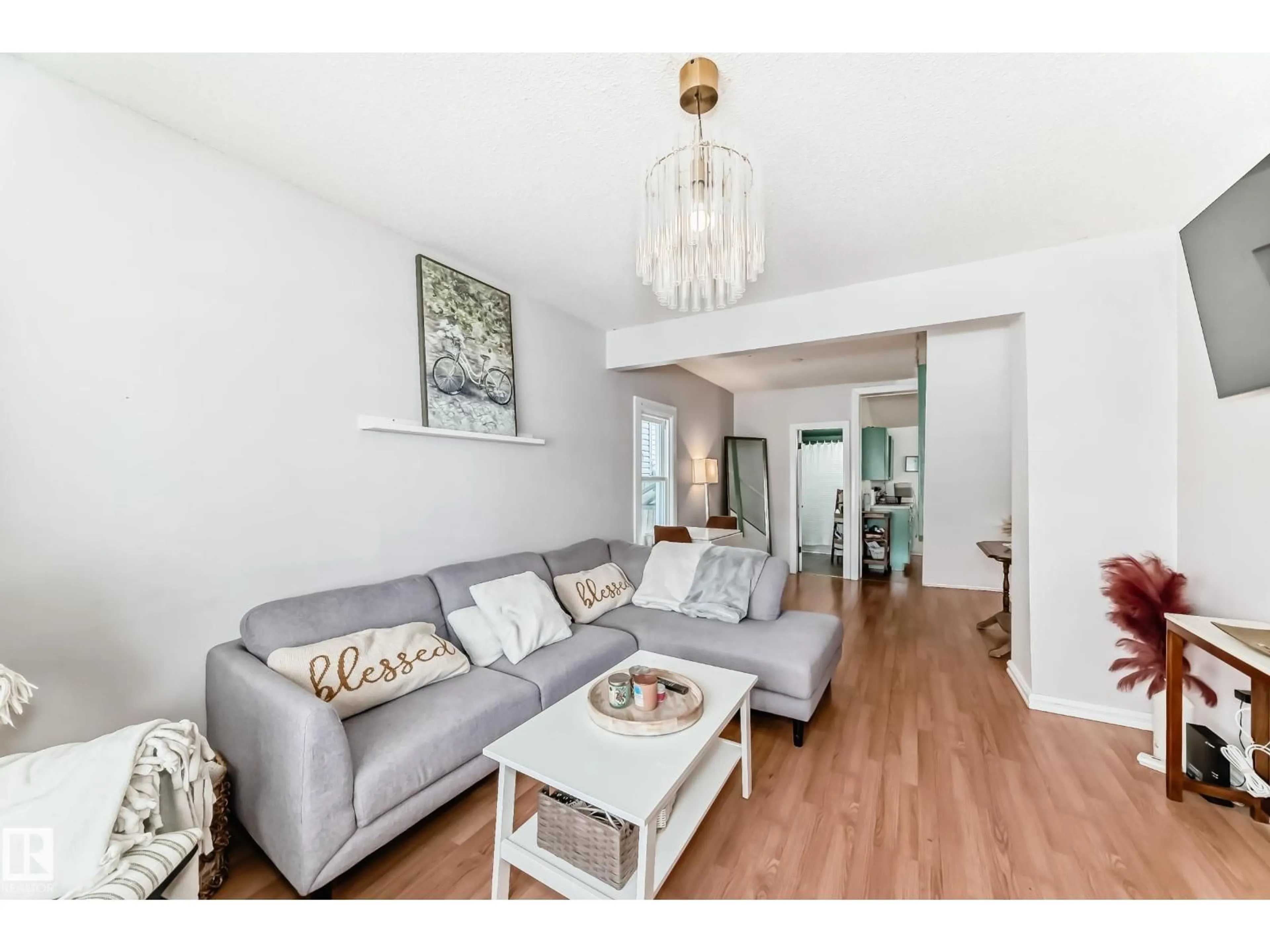 Living room with furniture, wood/laminate floor for NW - 10928 92 ST, Edmonton Alberta T5H1W1