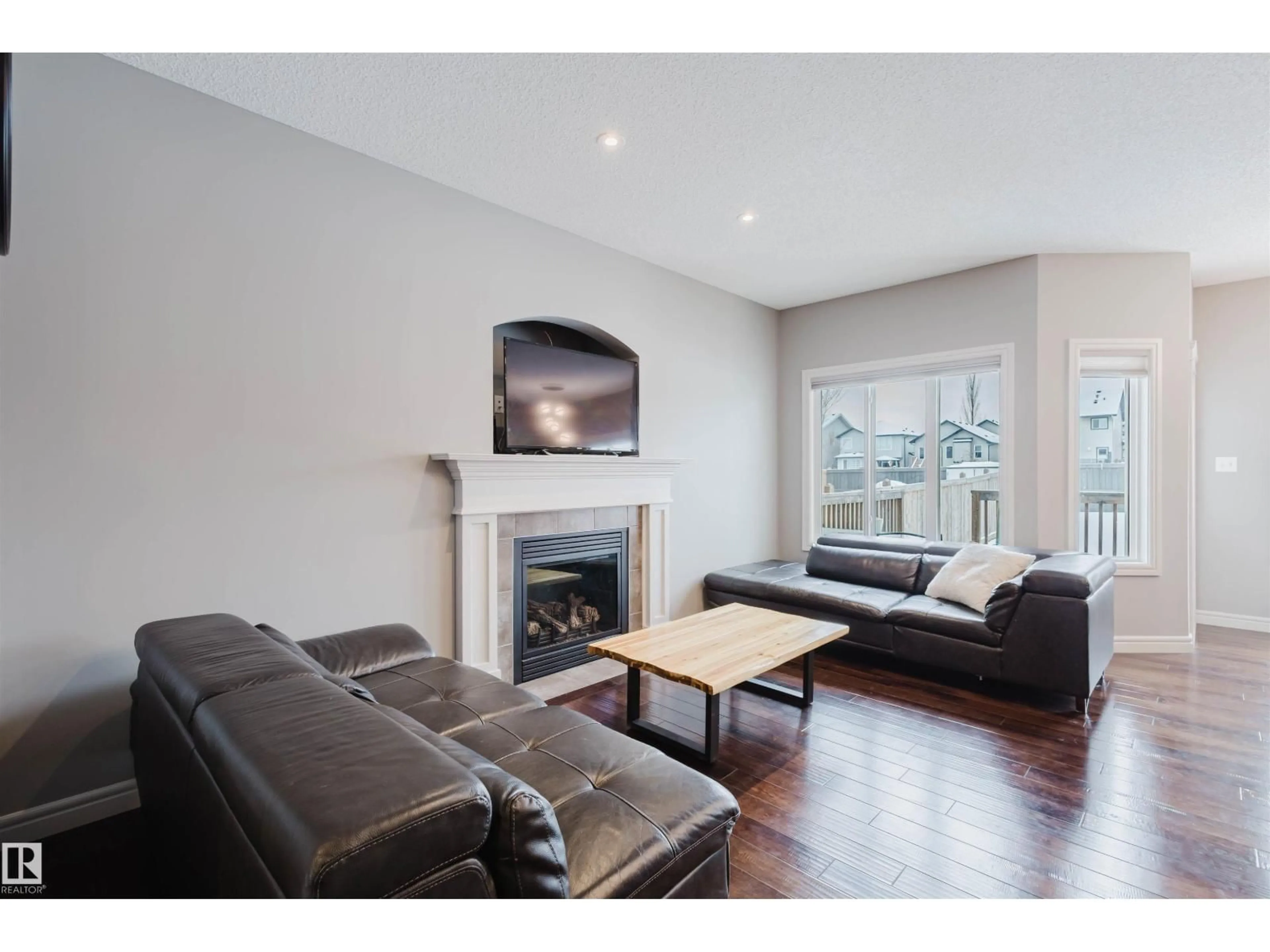 Living room with furniture, wood/laminate floor for 3921 167A AV, Edmonton Alberta T5Y0X9