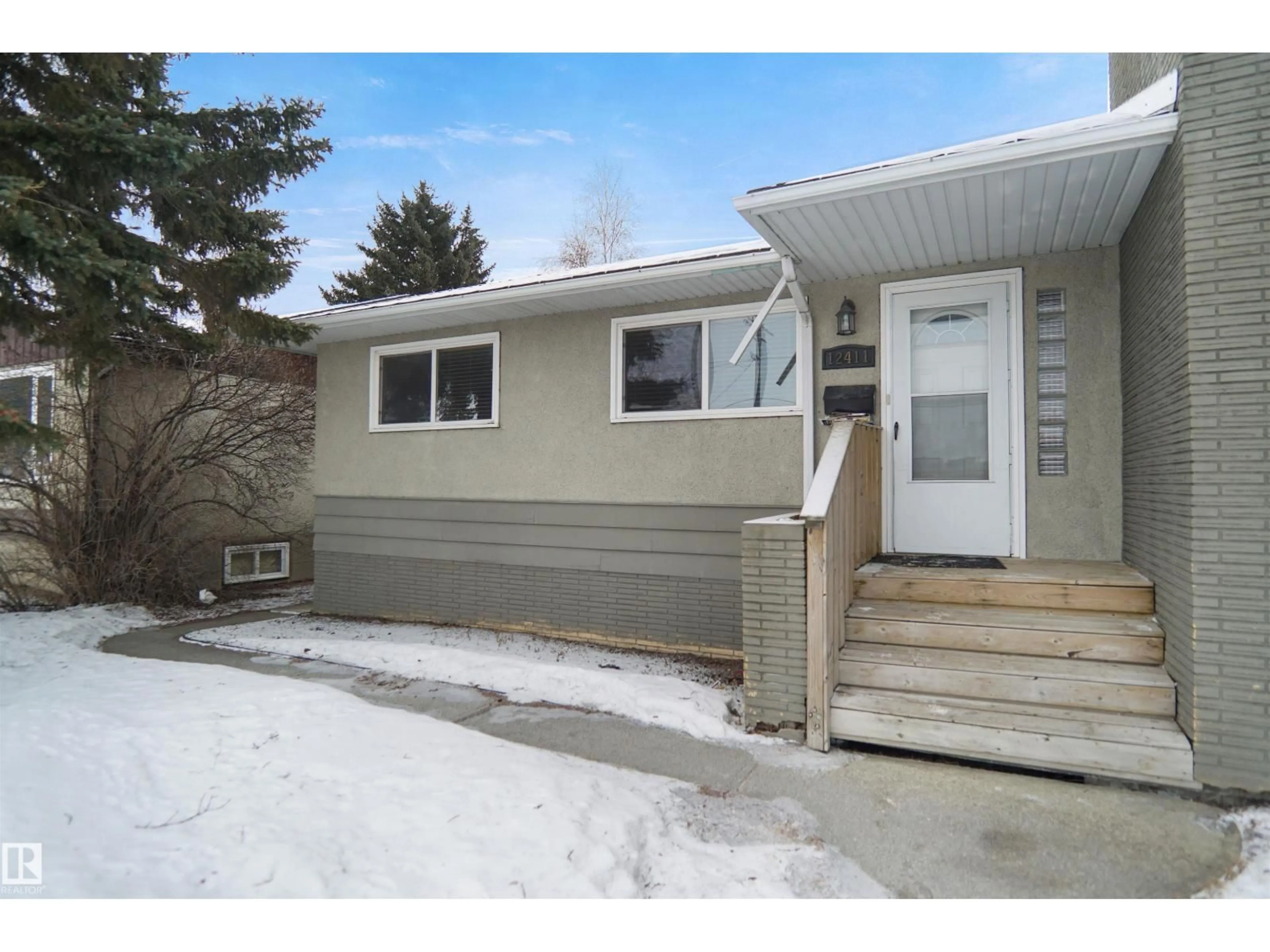 Home with vinyl exterior material, street for 12411 132 AV, Edmonton Alberta T5L3P8