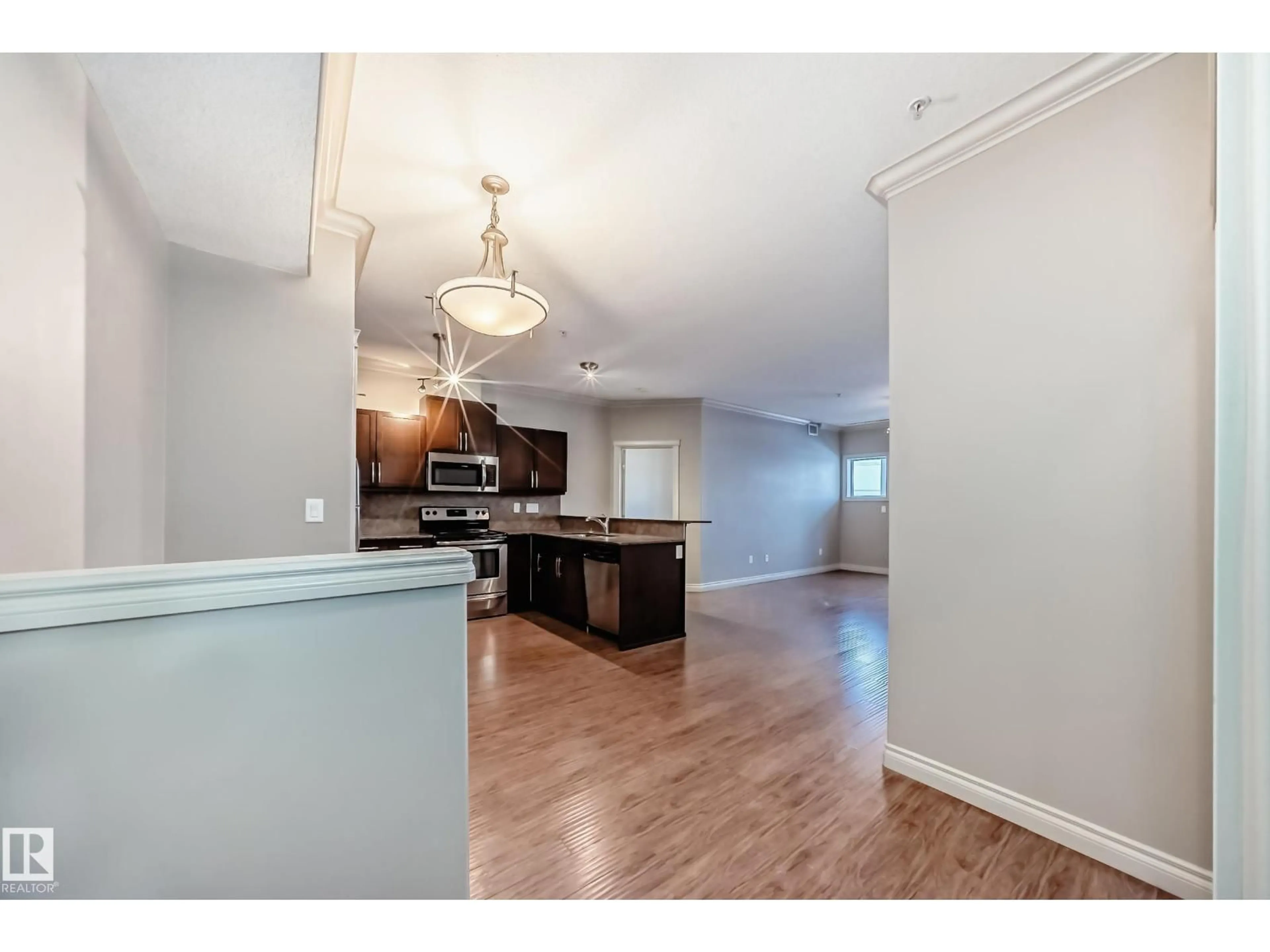 Open concept kitchen, wood/laminate floor for NW - 348 10121 80 AV, Edmonton Alberta T6E0B9