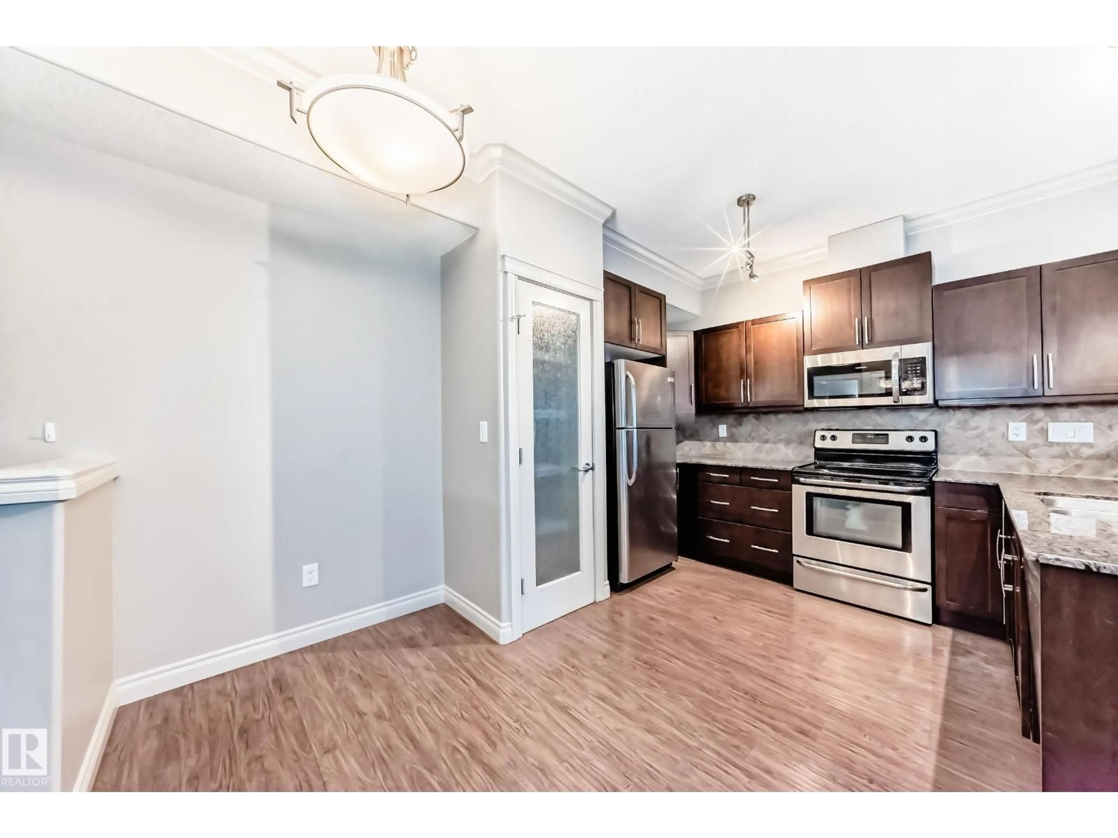 Open concept kitchen, wood/laminate floor for NW - 348 10121 80 AV, Edmonton Alberta T6E0B9