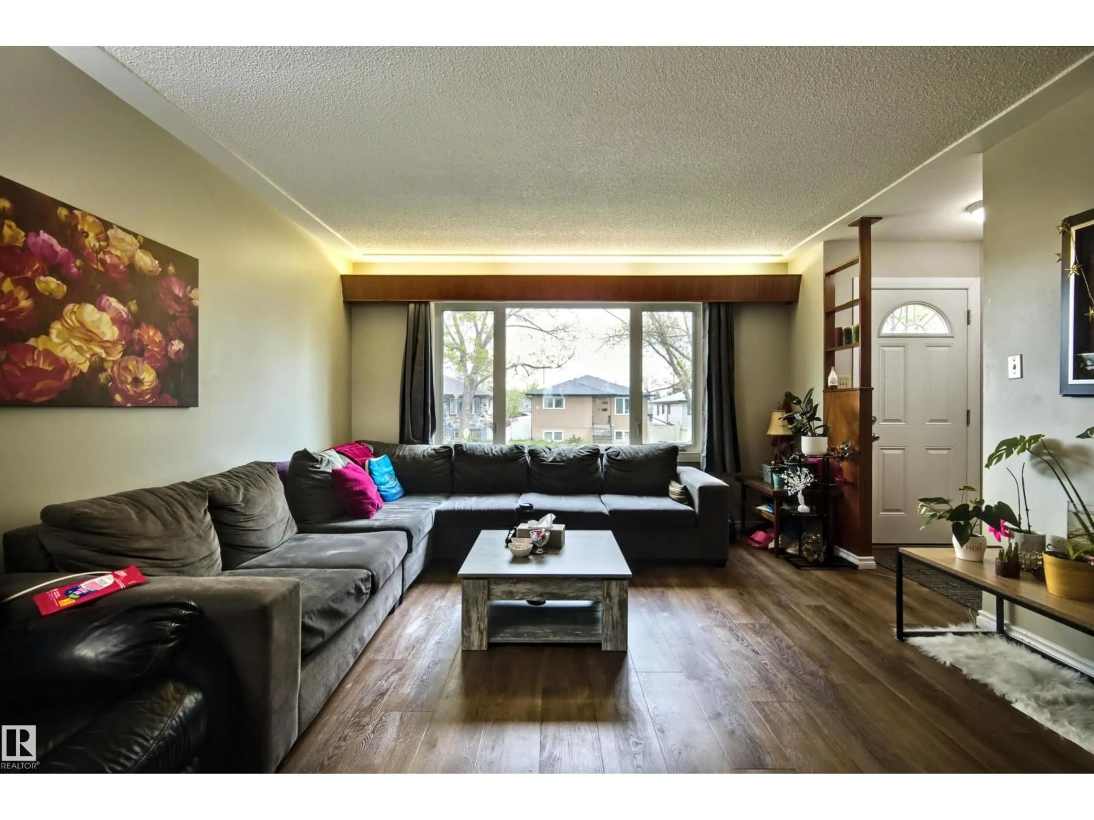 Living room with furniture, wood/laminate floor for NW - 13008-13010 102 ST, Edmonton Alberta T6H4B2