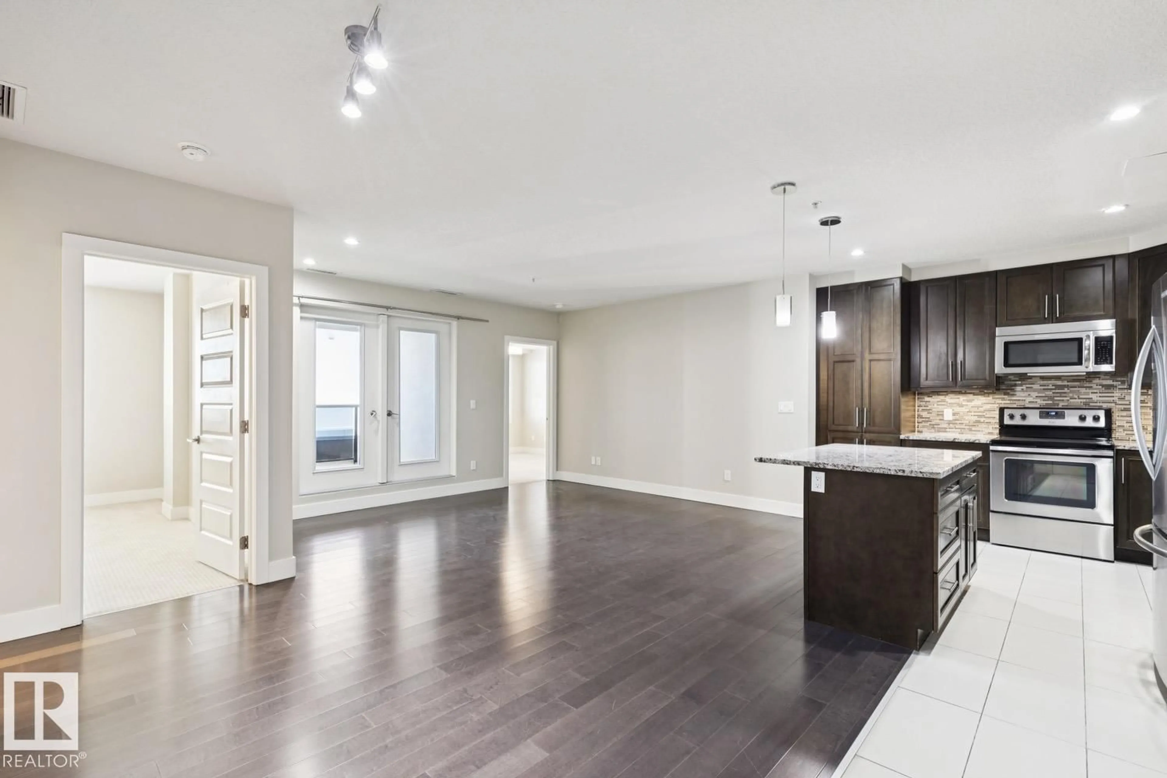 Open concept kitchen, wood/laminate floor for #208 - 1350 WINDERMERE WY, Edmonton Alberta T6W2J3