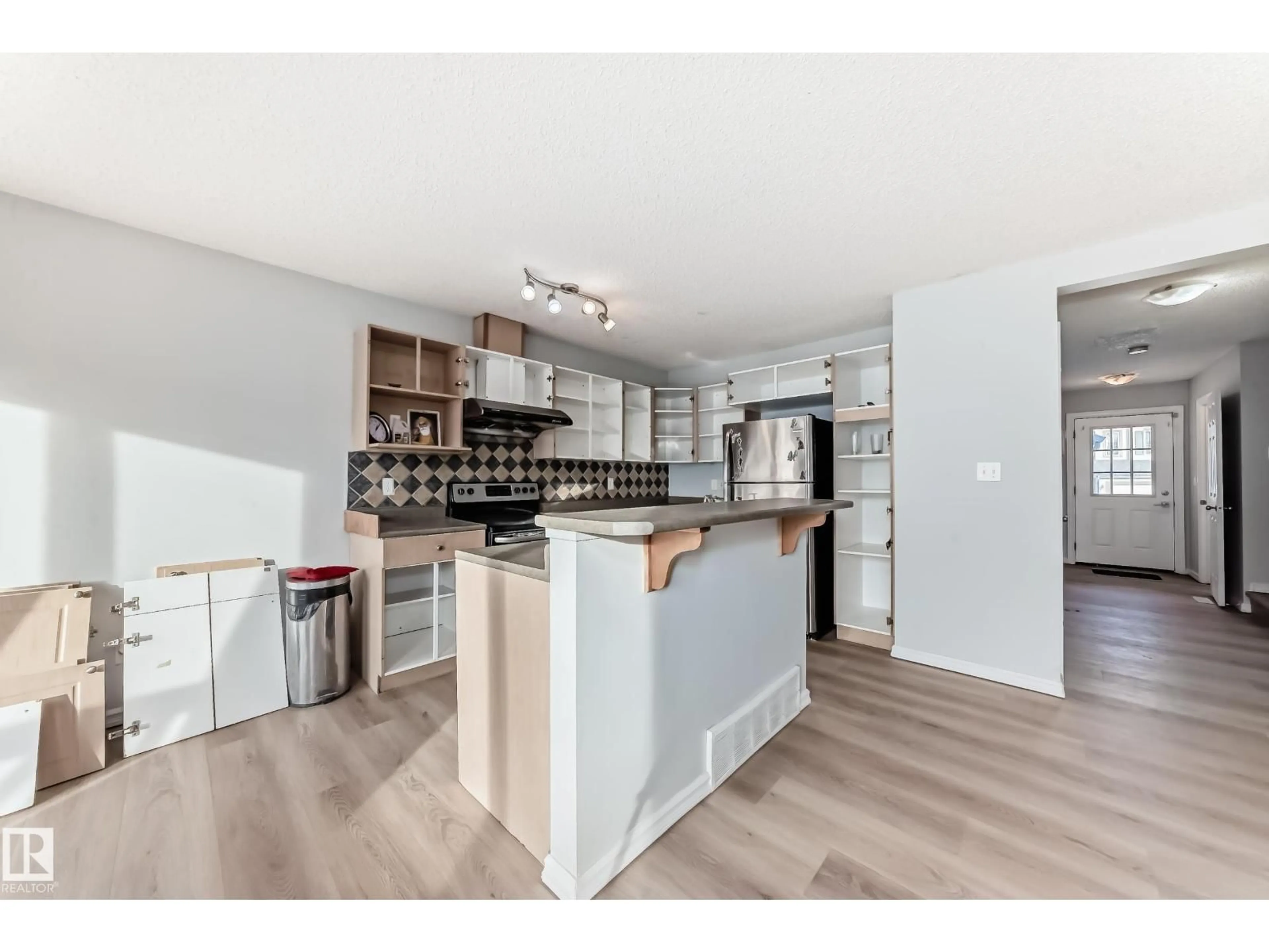 Open concept kitchen, wood/laminate floor for 7731 8 AV, Edmonton Alberta T6X0A3