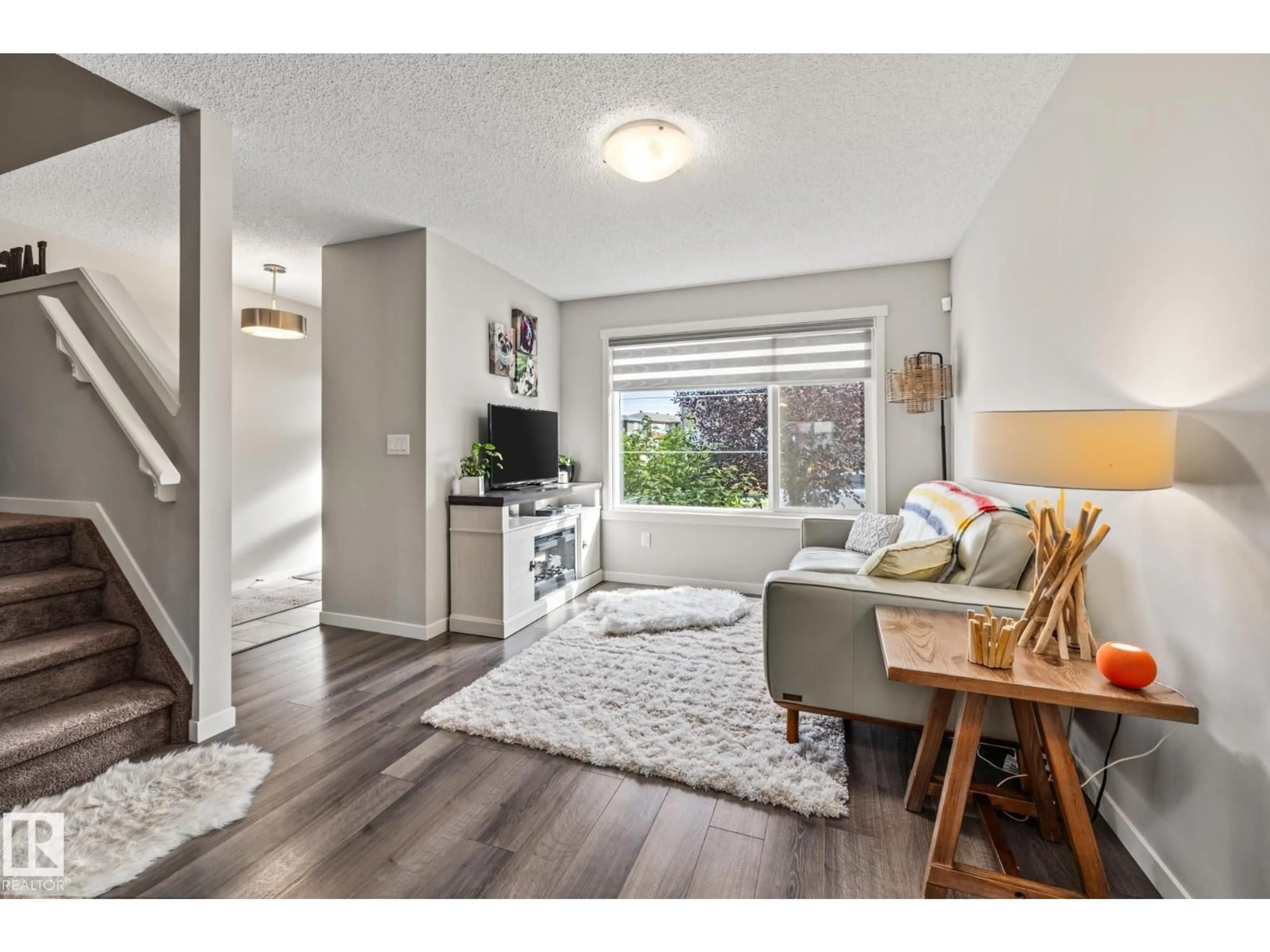 Living room with furniture, wood/laminate floor for 20110 27 AV, Edmonton Alberta T6M0W7