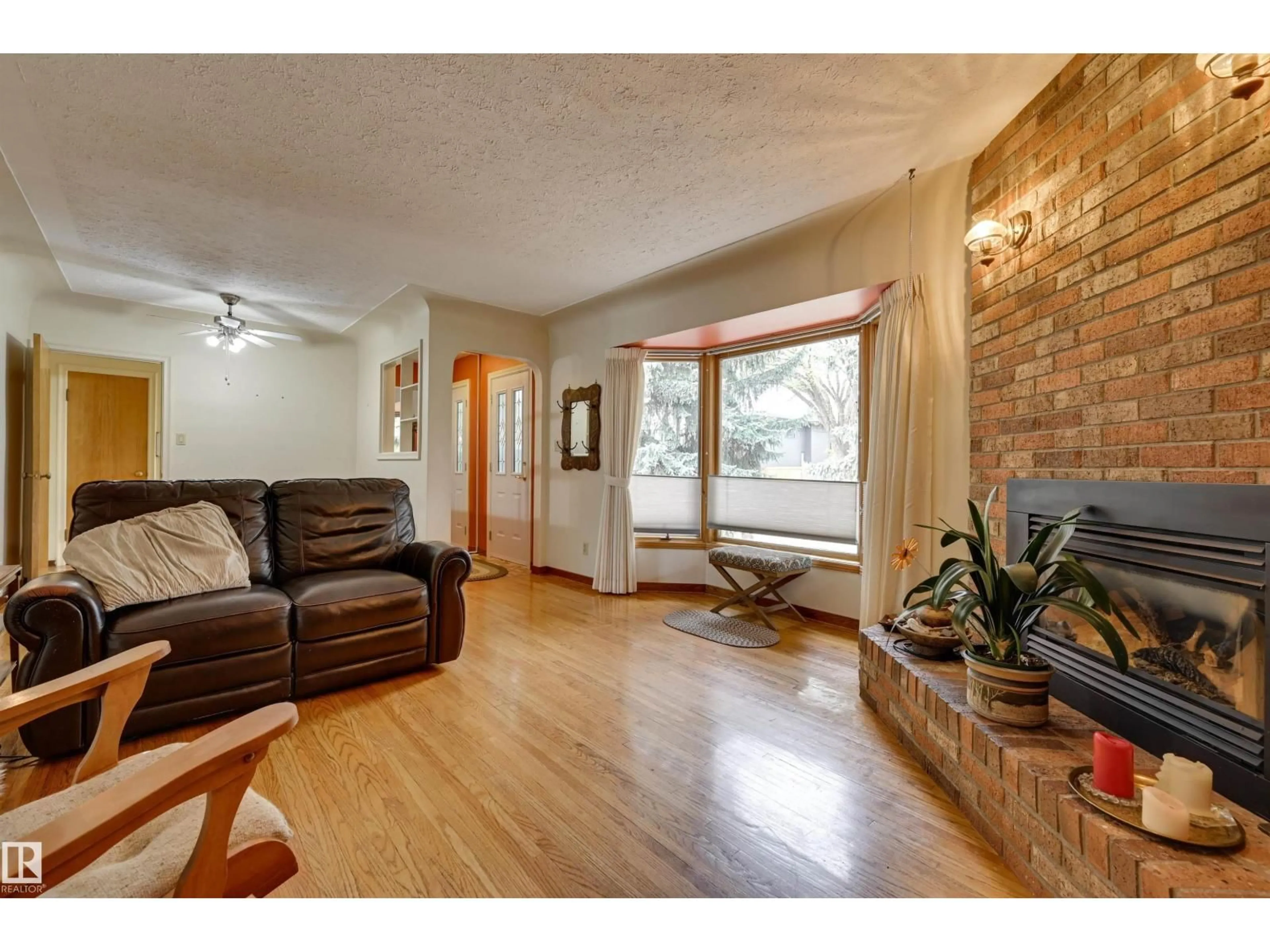 Living room with furniture, wood/laminate floor for 9725 143 ST, Edmonton Alberta T5N2R3