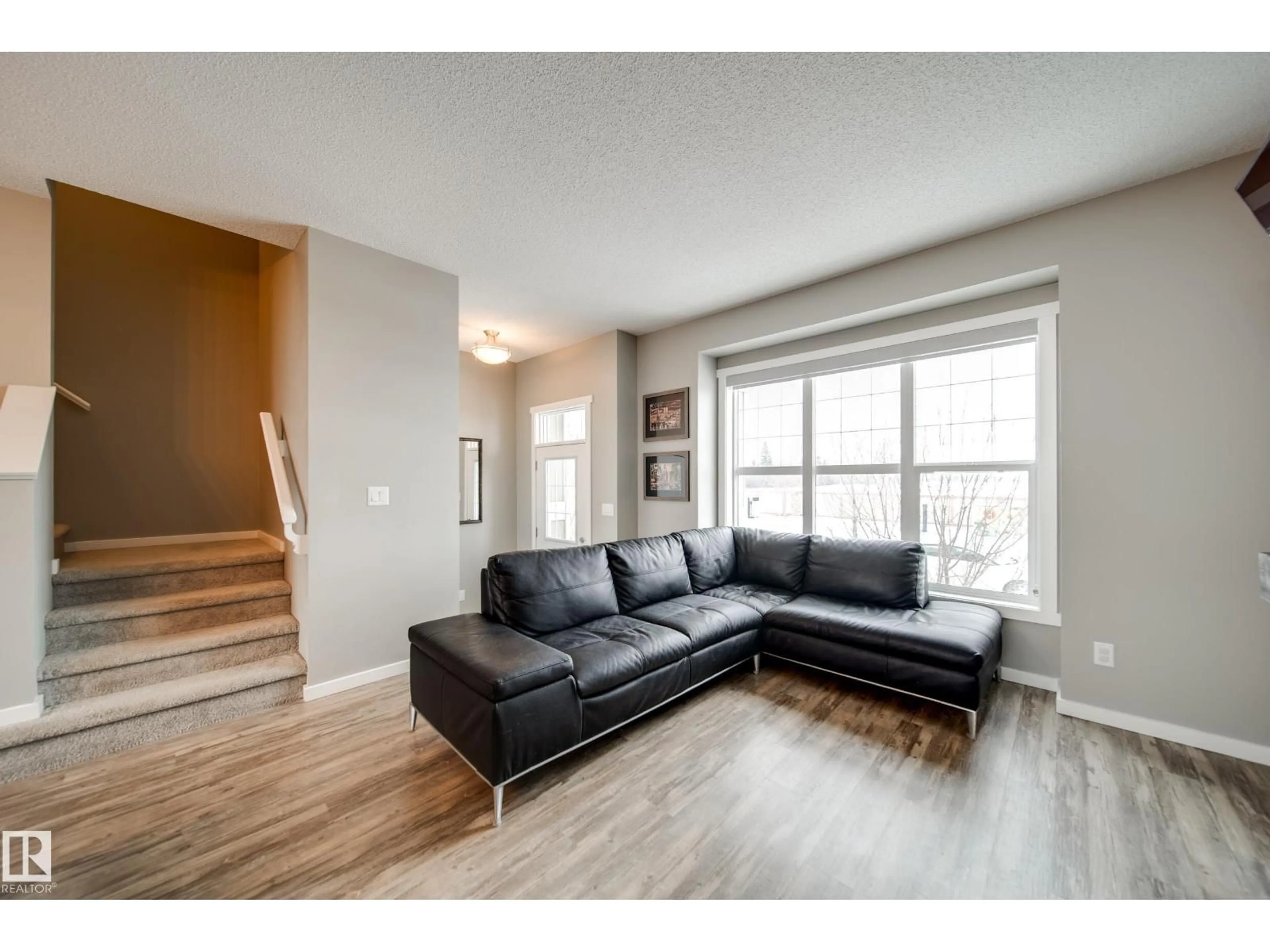 Living room with furniture, wood/laminate floor for 124 SOUTHFORK RD, Leduc Alberta T9E1E2