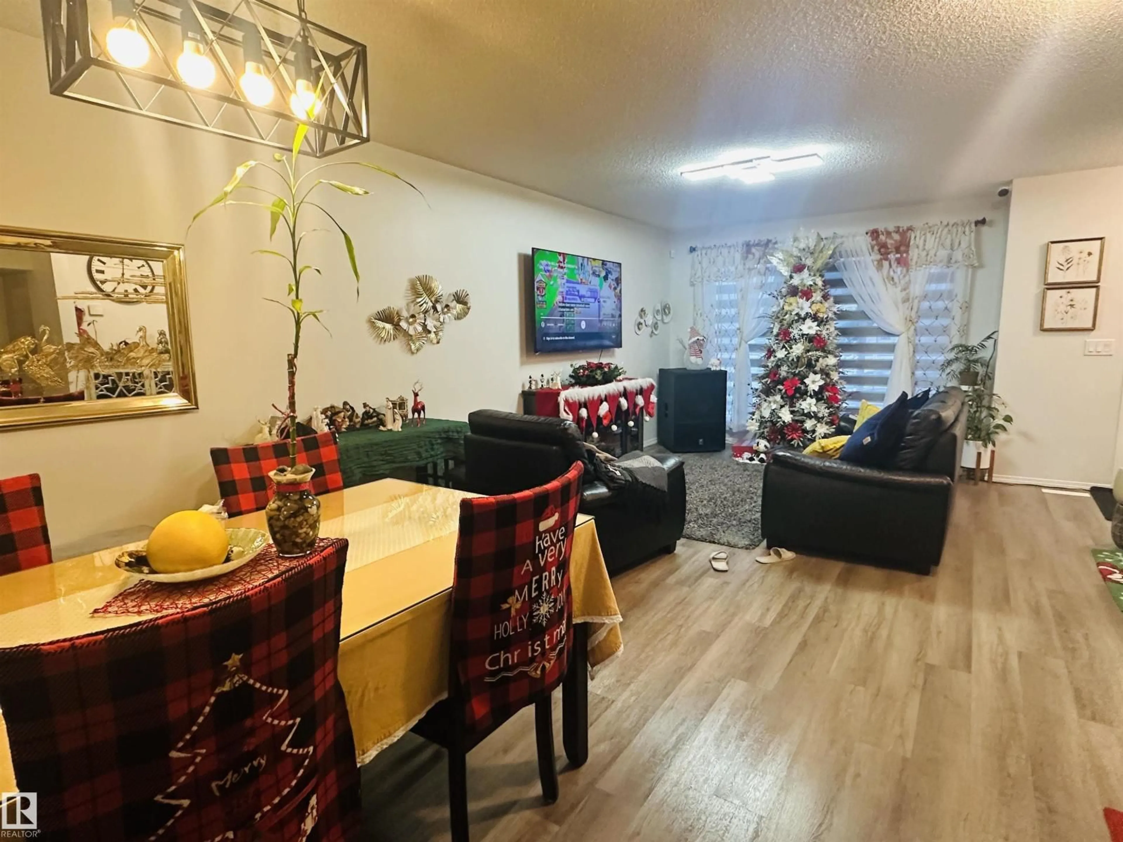 Living room with furniture, wood/laminate floor for 19303 27 AV, Edmonton Alberta T6M1K9