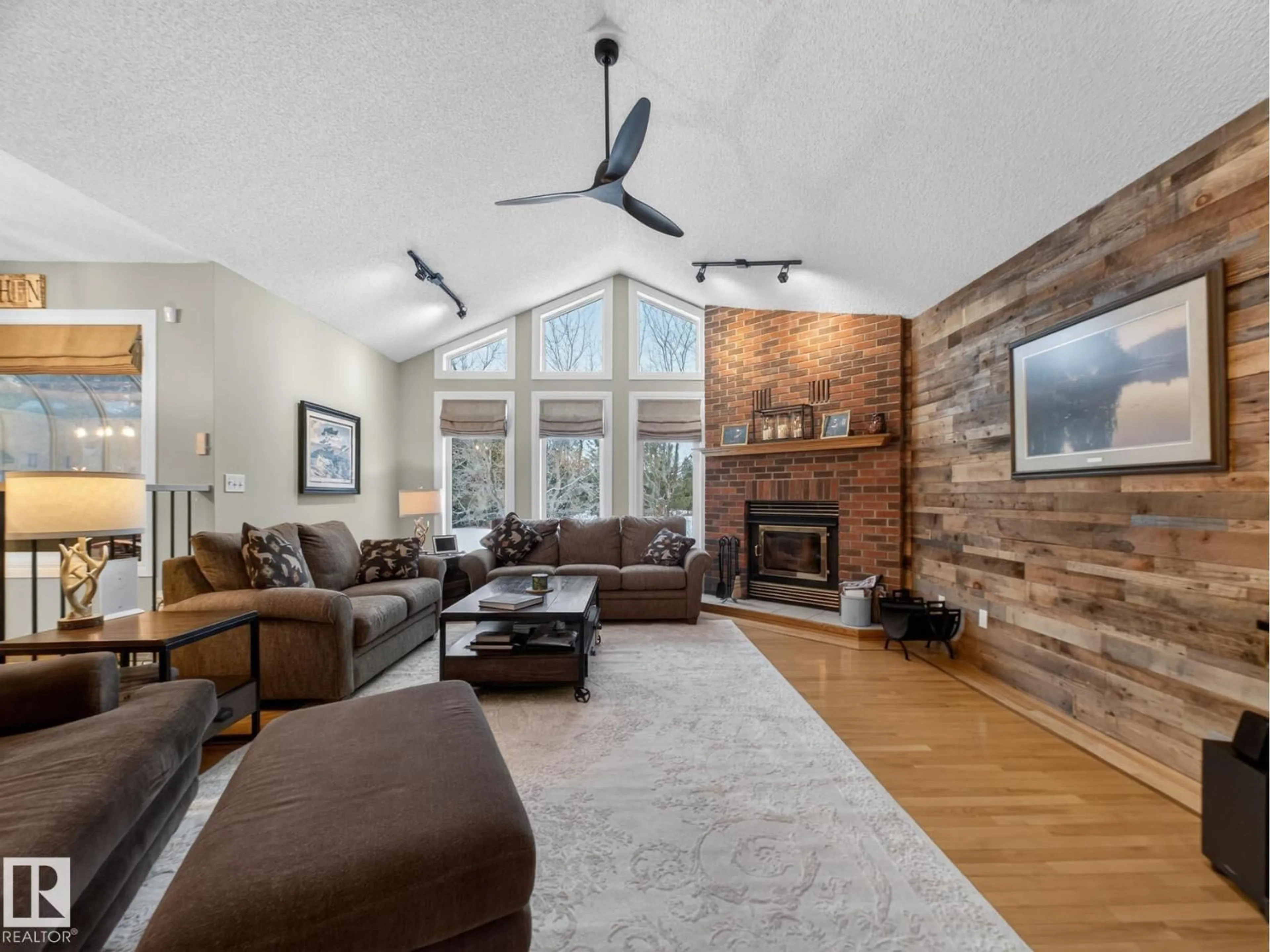 Living room with furniture, wood/laminate floor for 51350 - 230 RGE RD 224, Rural Strathcona County Alberta T8C1H3