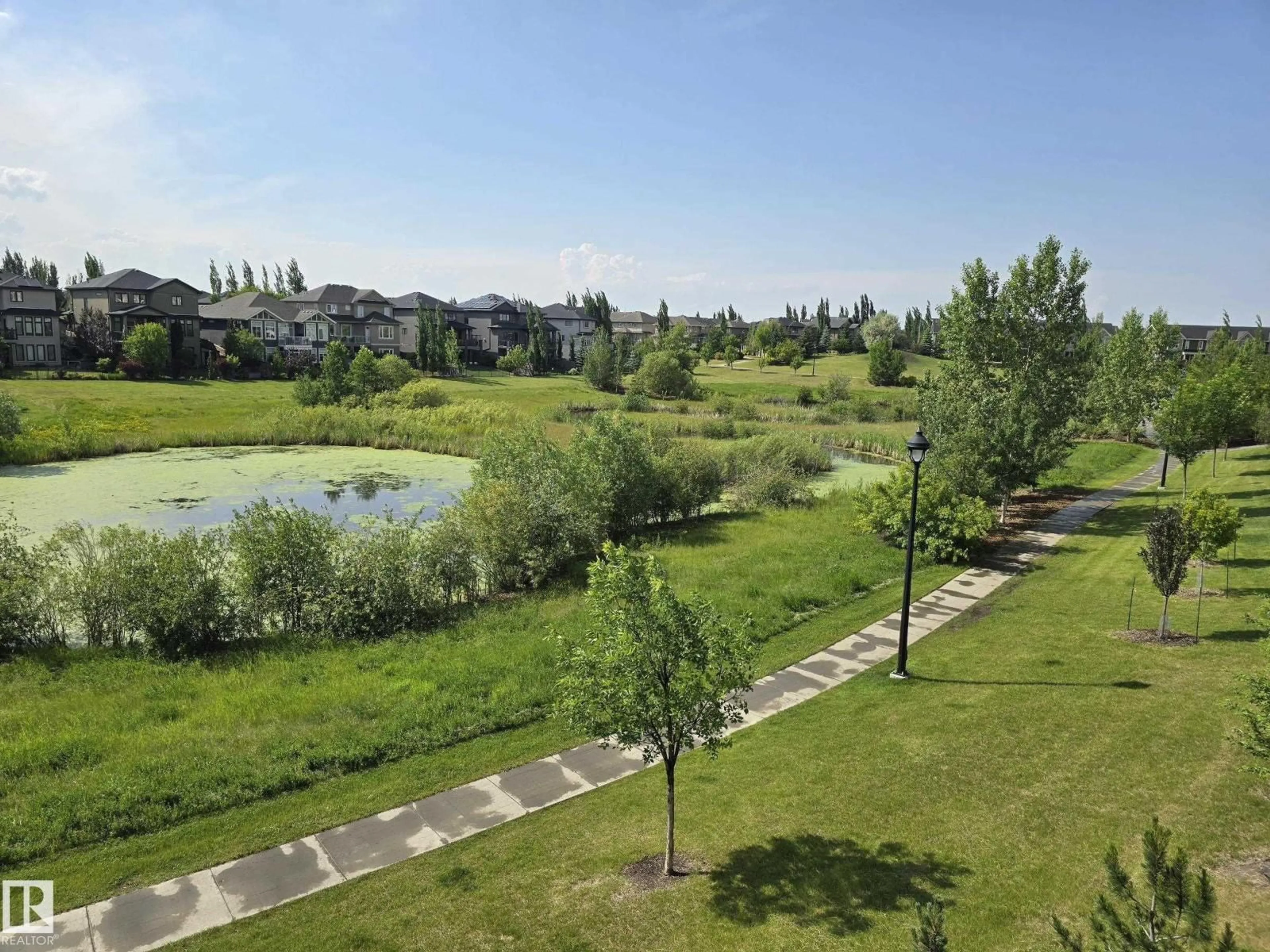 A pic from outside/outdoor area/front of a property/back of a property/a pic from drone, water/lake/river/ocean view for #206 - 1316 WINDERMERE WY, Edmonton Alberta T6W0P1