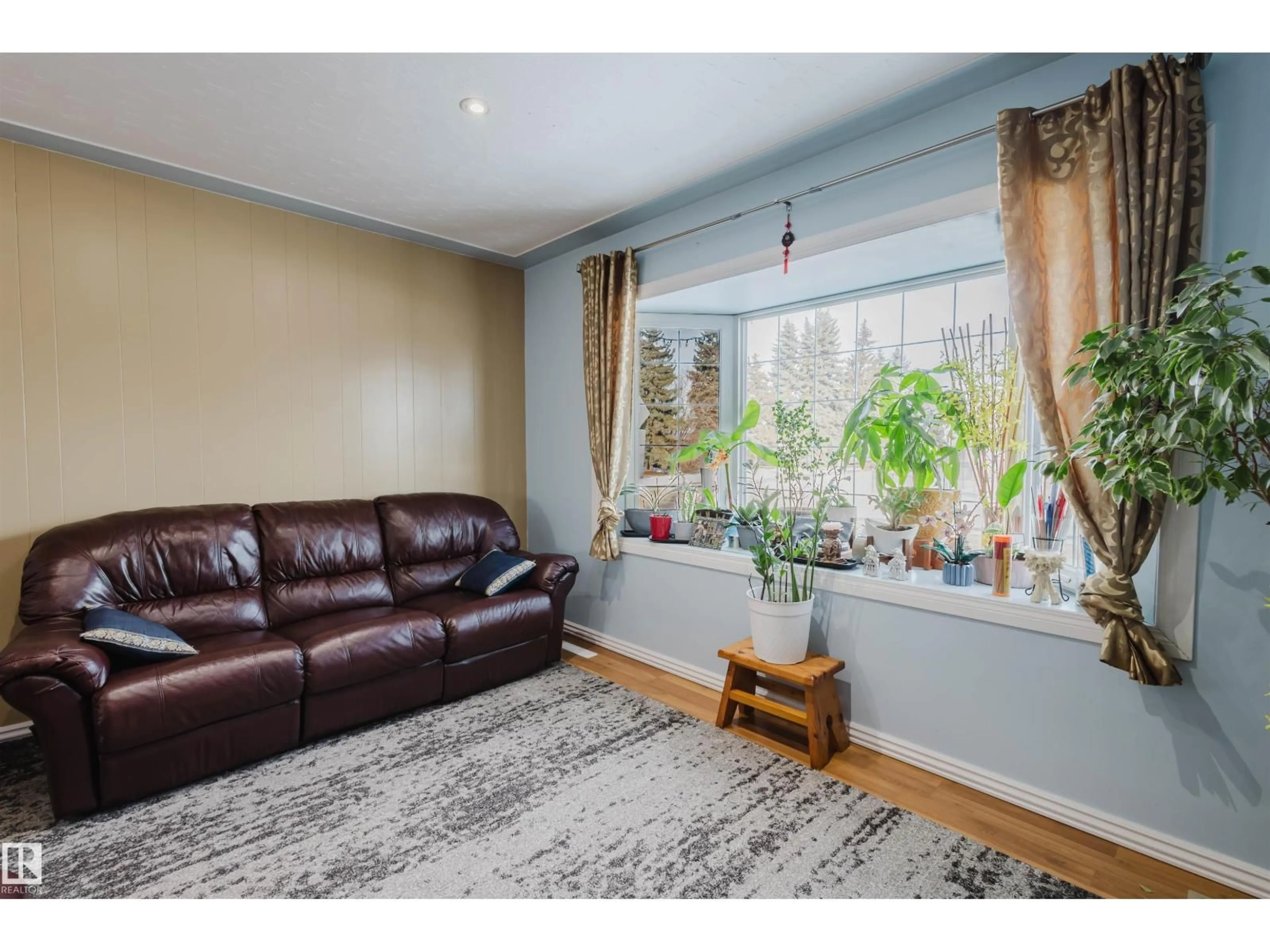 Living room with furniture, wood/laminate floor for 13315 134 AV NW, Edmonton Alberta T5L3V7