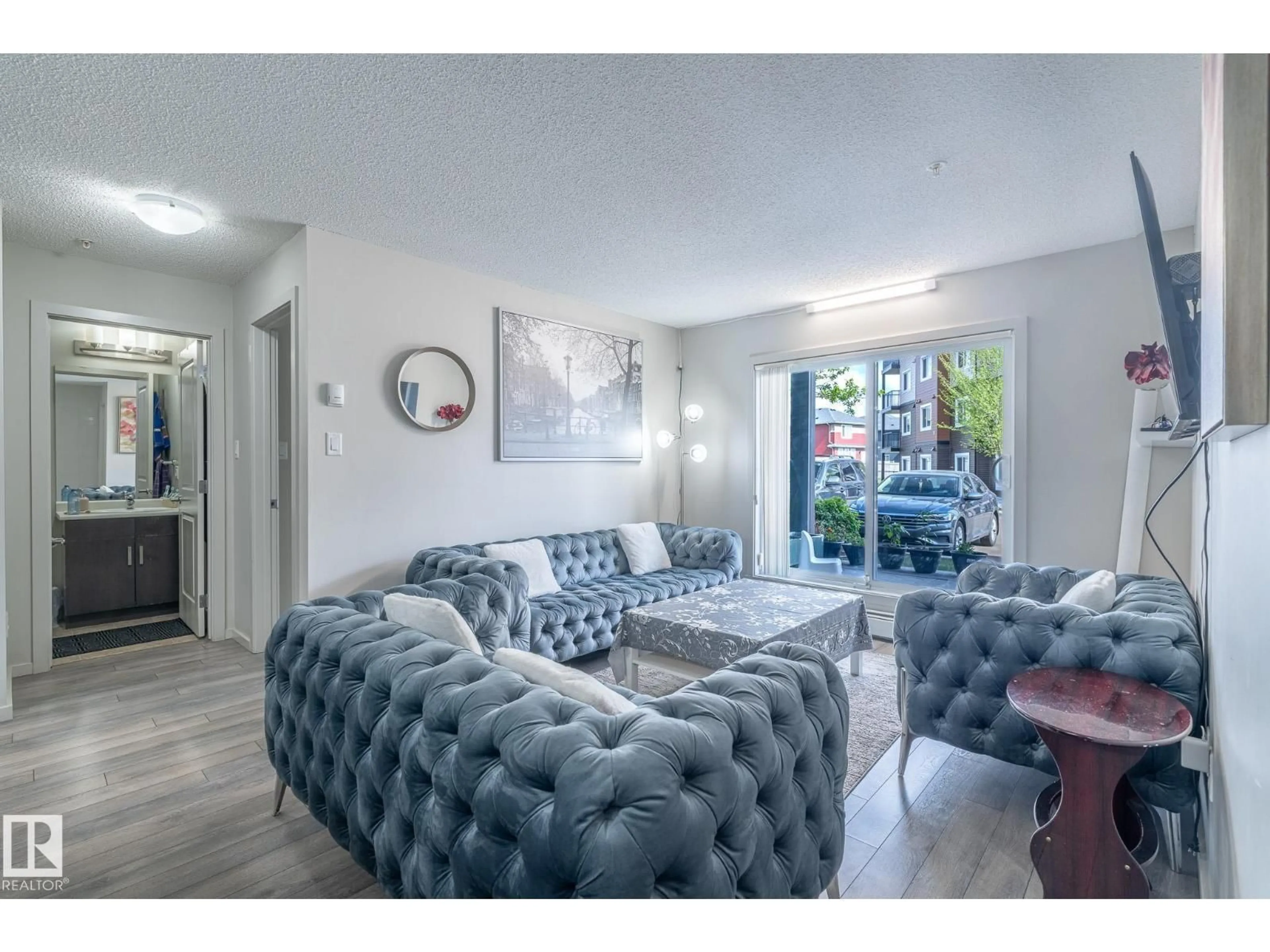 Living room with furniture, unknown for #107 - 142 EBBERS BV, Edmonton Alberta T5Y3W2