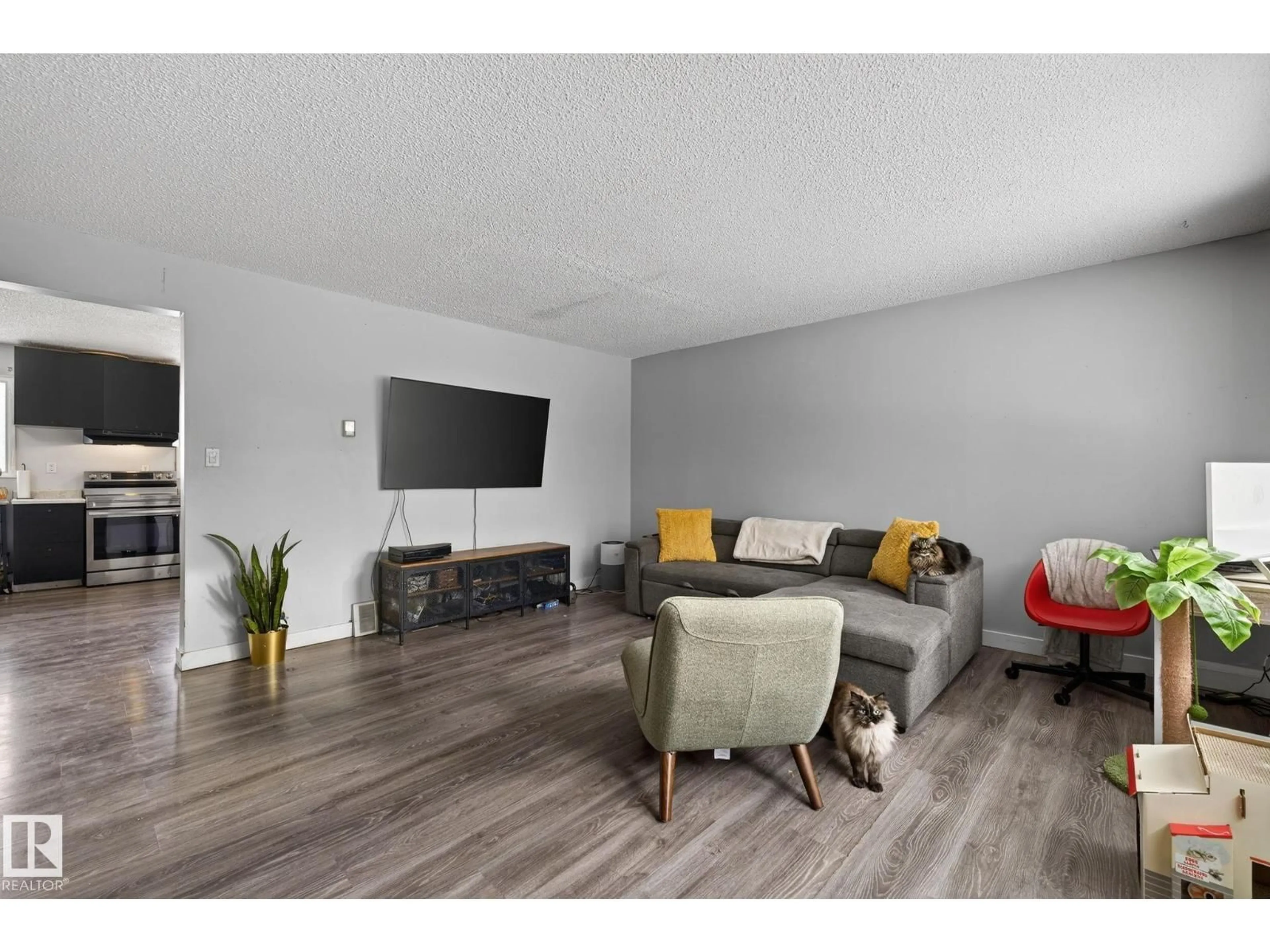 Living room with furniture, wood/laminate floor for 6714 149 AV, Edmonton Alberta T5C2V2