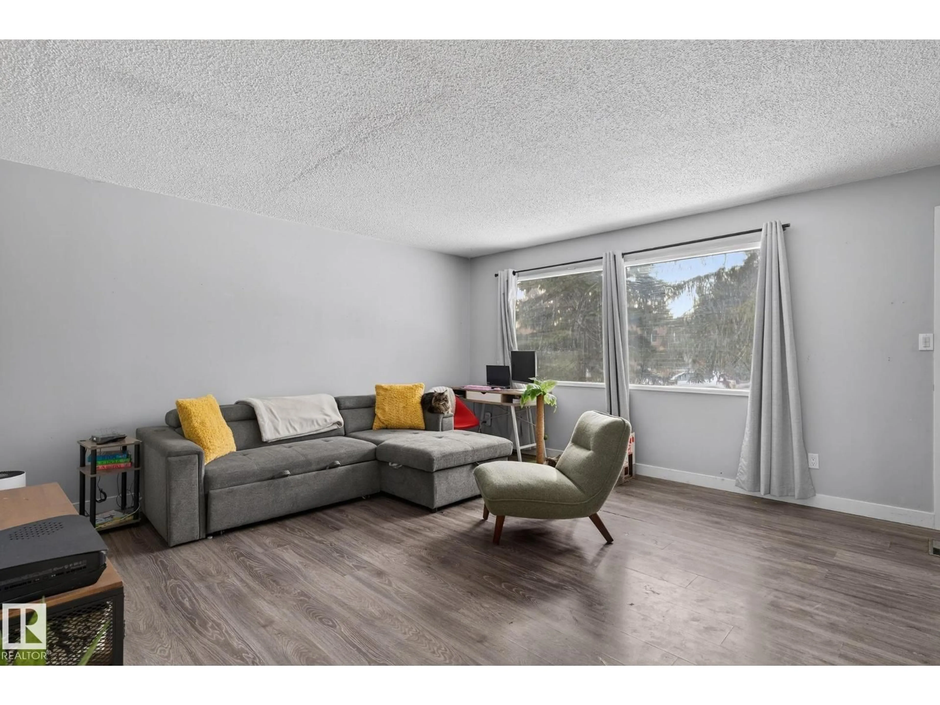 Living room with furniture, wood/laminate floor for 6714 149 AV, Edmonton Alberta T5C2V2