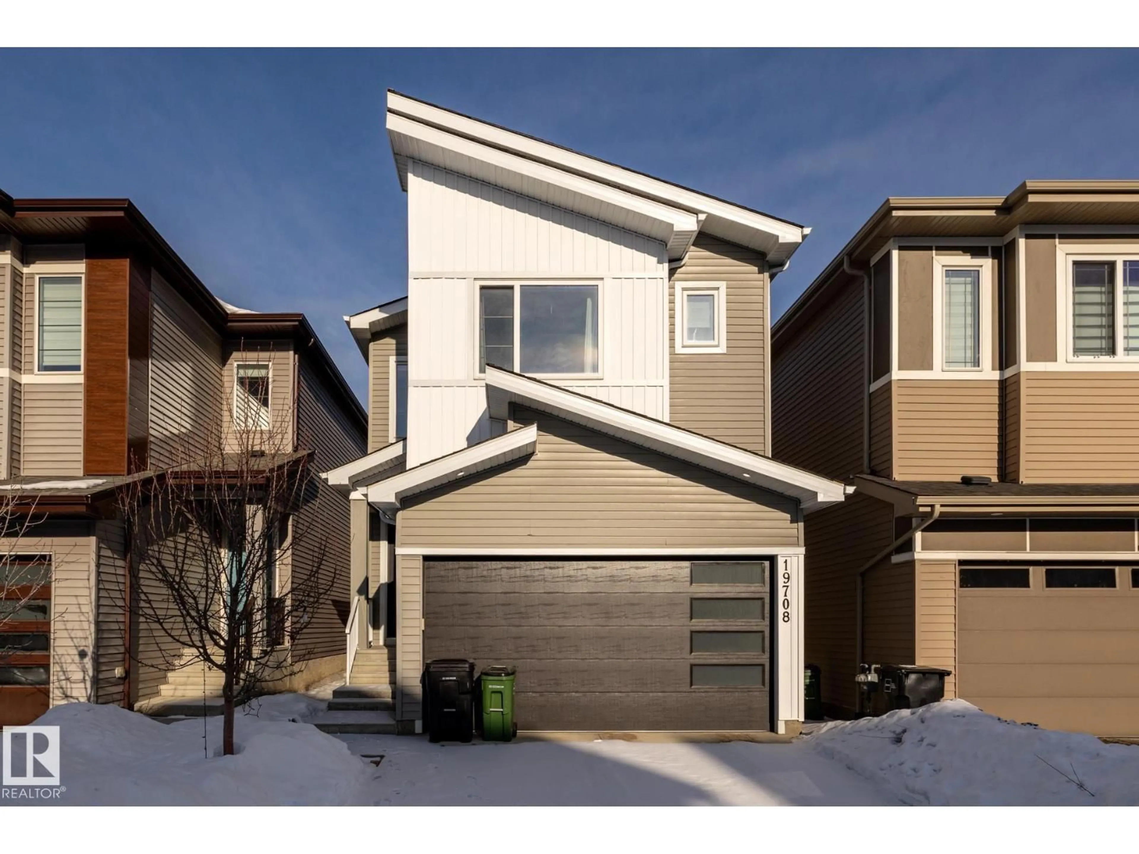 Home with vinyl exterior material, street for 19708 28 AV, Edmonton Alberta T6M1M1