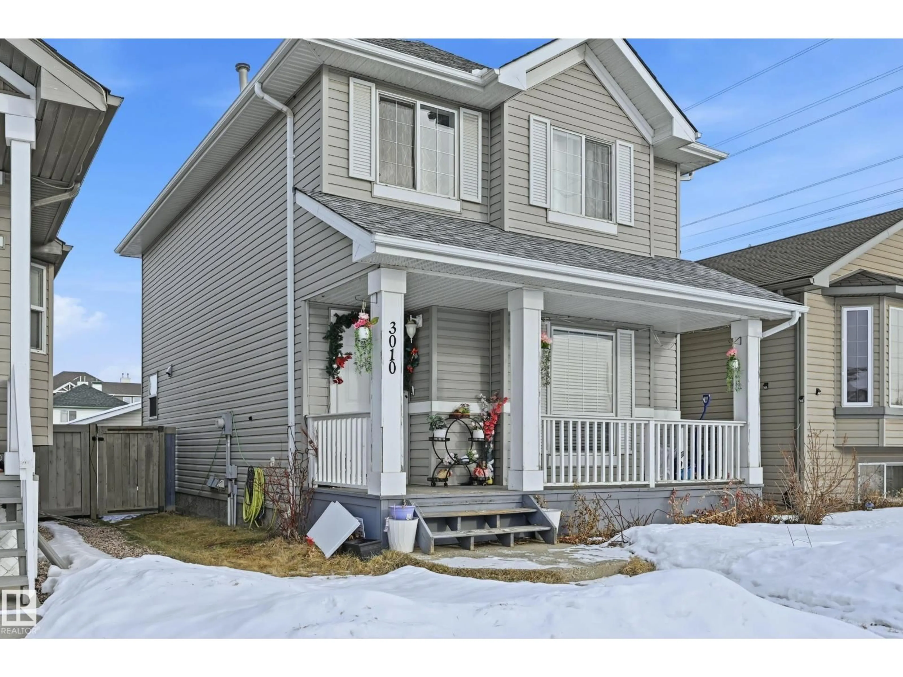 Home with vinyl exterior material, street for 3010 32 AV NW, Edmonton Alberta T6T1X1