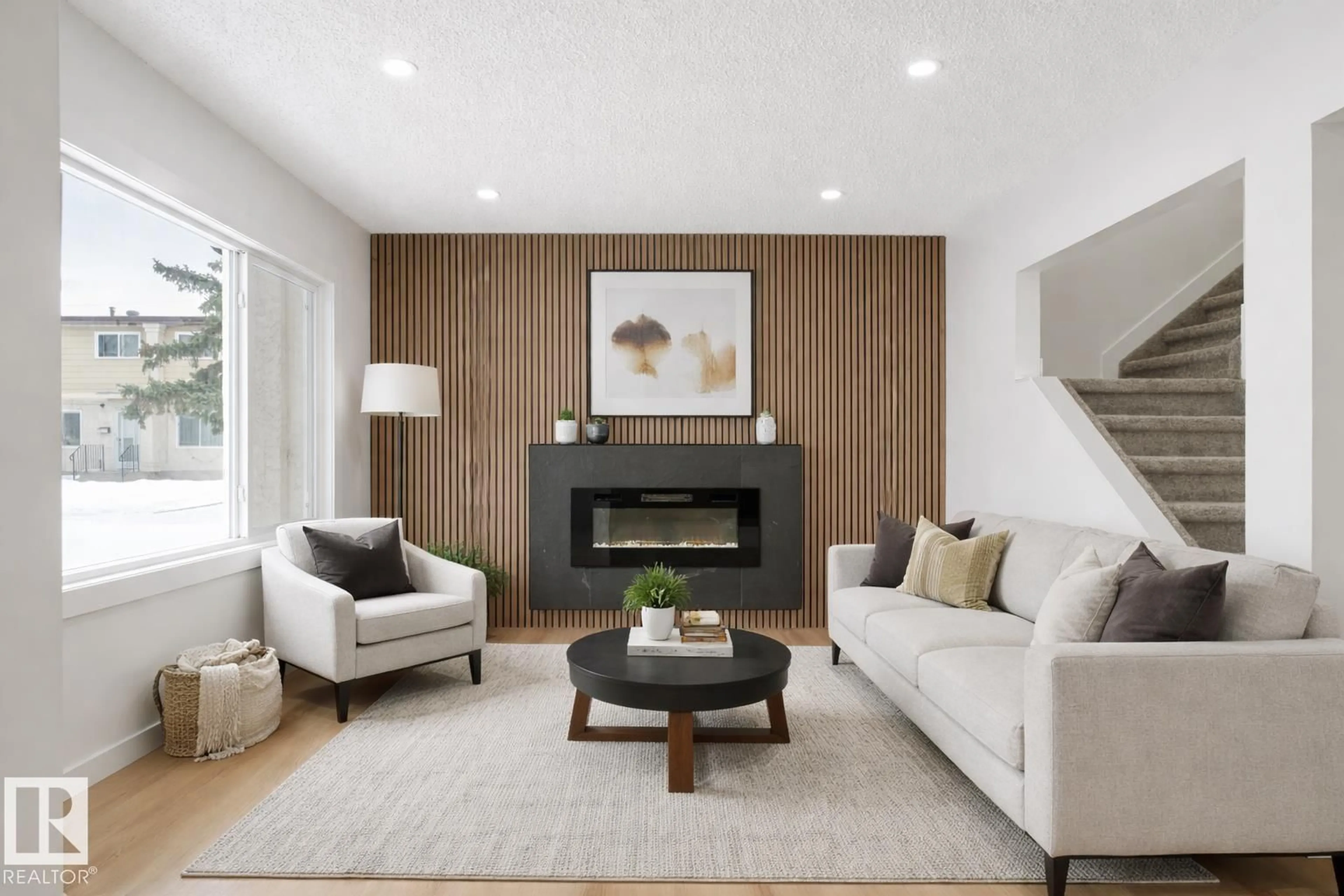 Living room with furniture, wood/laminate floor for NW - 5105 106A ST, Edmonton Alberta T6H2W6