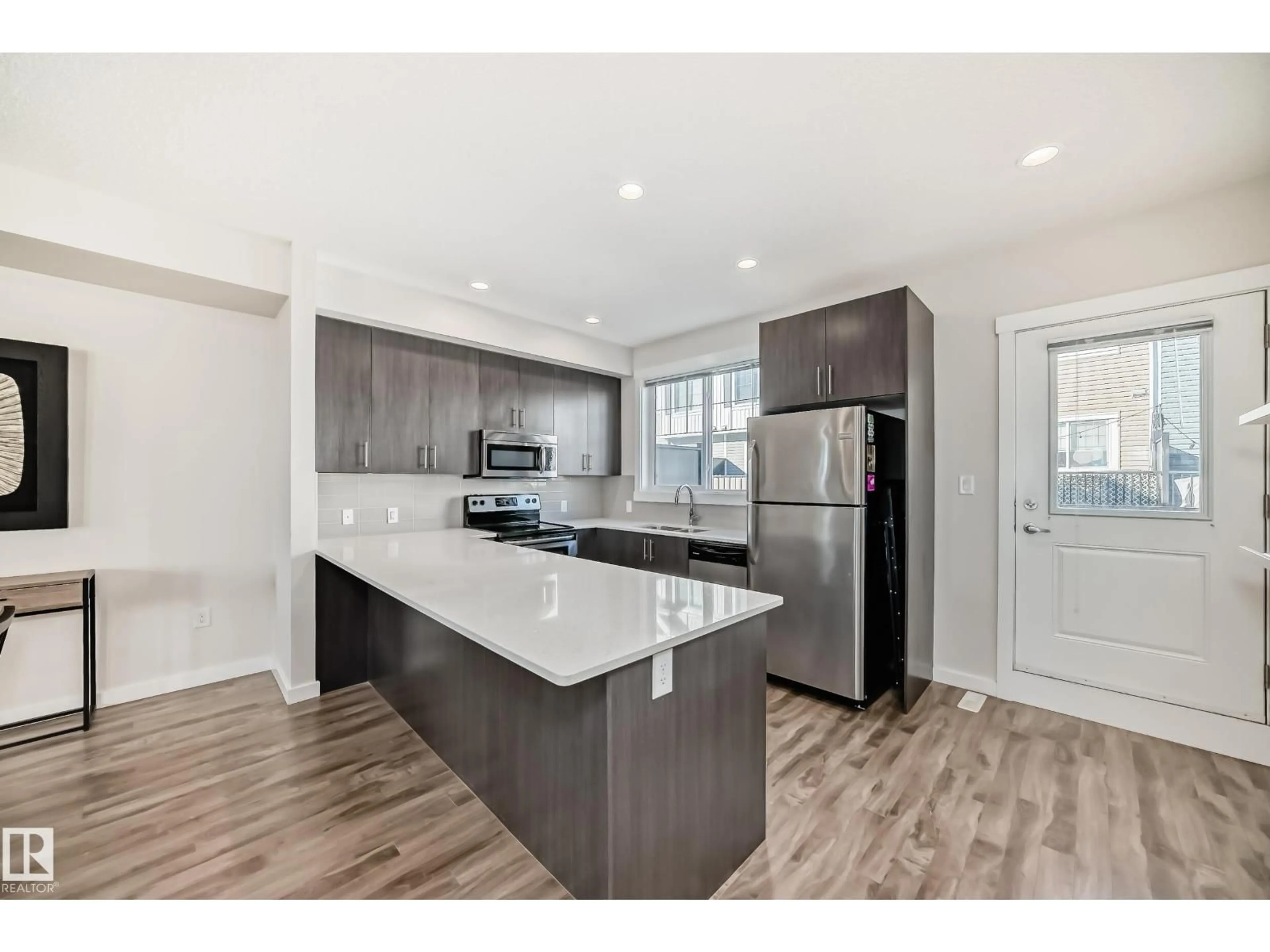 Open concept kitchen, wood/laminate floor for 903 - 60 CRYSTALLINA NERA WY, Edmonton Alberta T5Z0N6