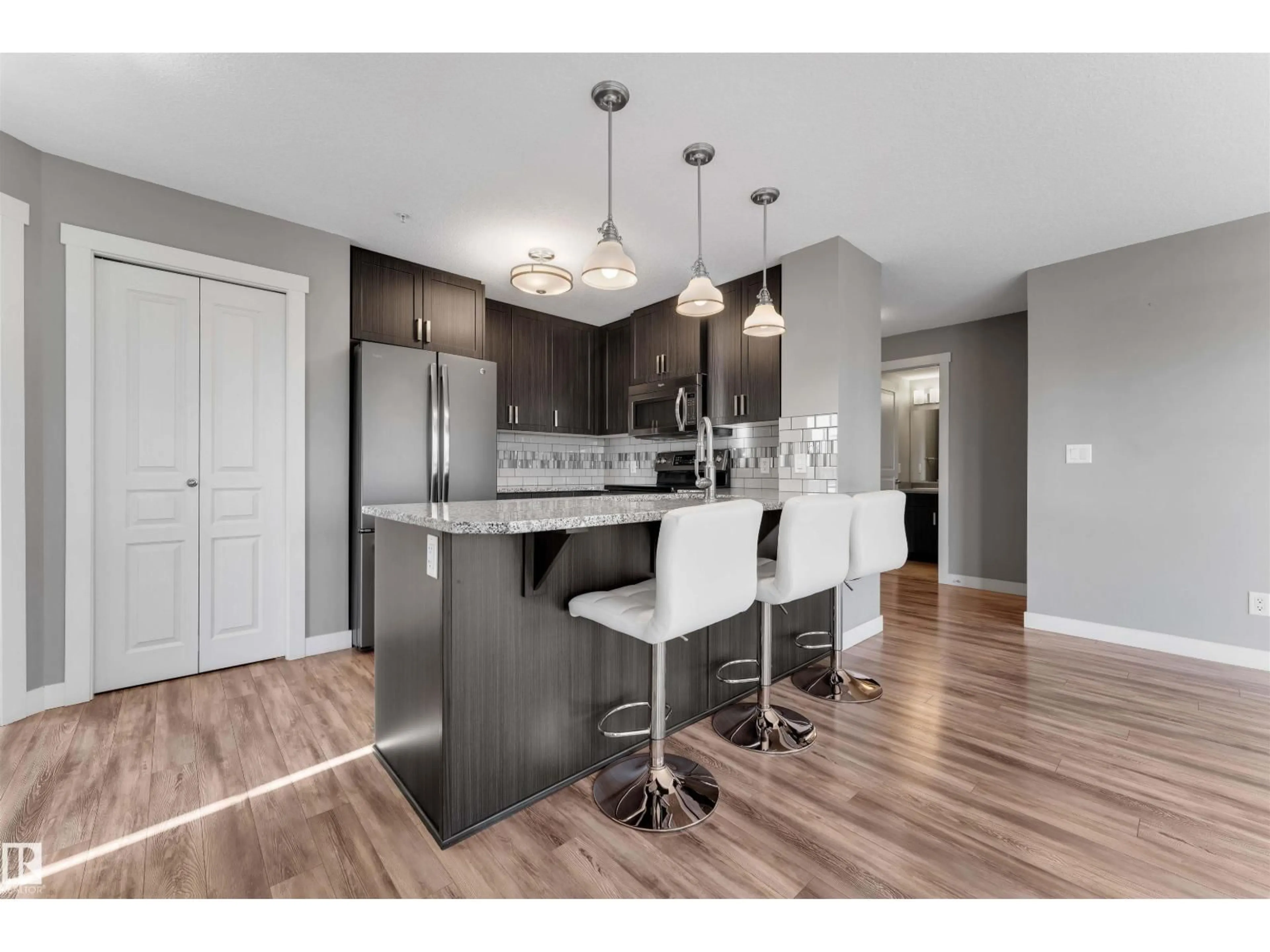 Open concept kitchen, wood/laminate floor for 319 - 3670 139 AV NW, Edmonton Alberta T5Y3N5