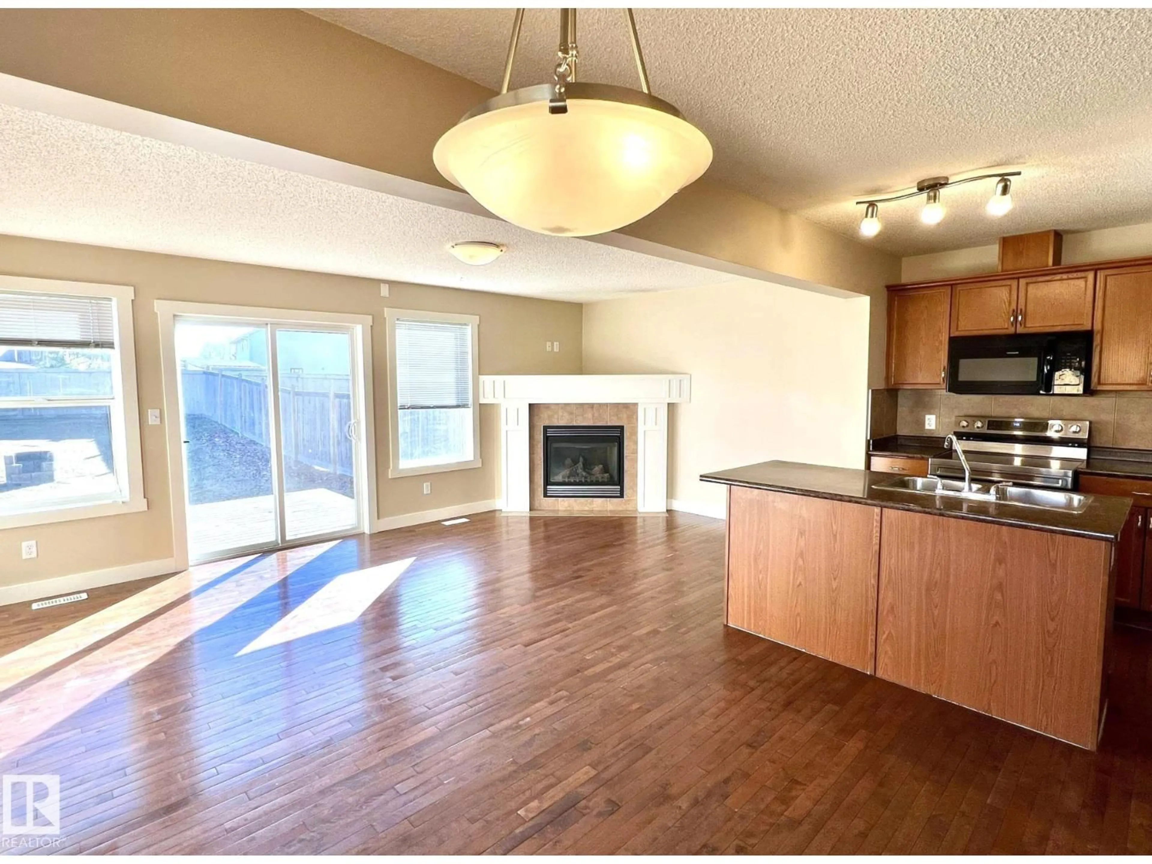 Open concept kitchen, wood/laminate floor for 3705 11 ST, Edmonton Alberta T6T0E8