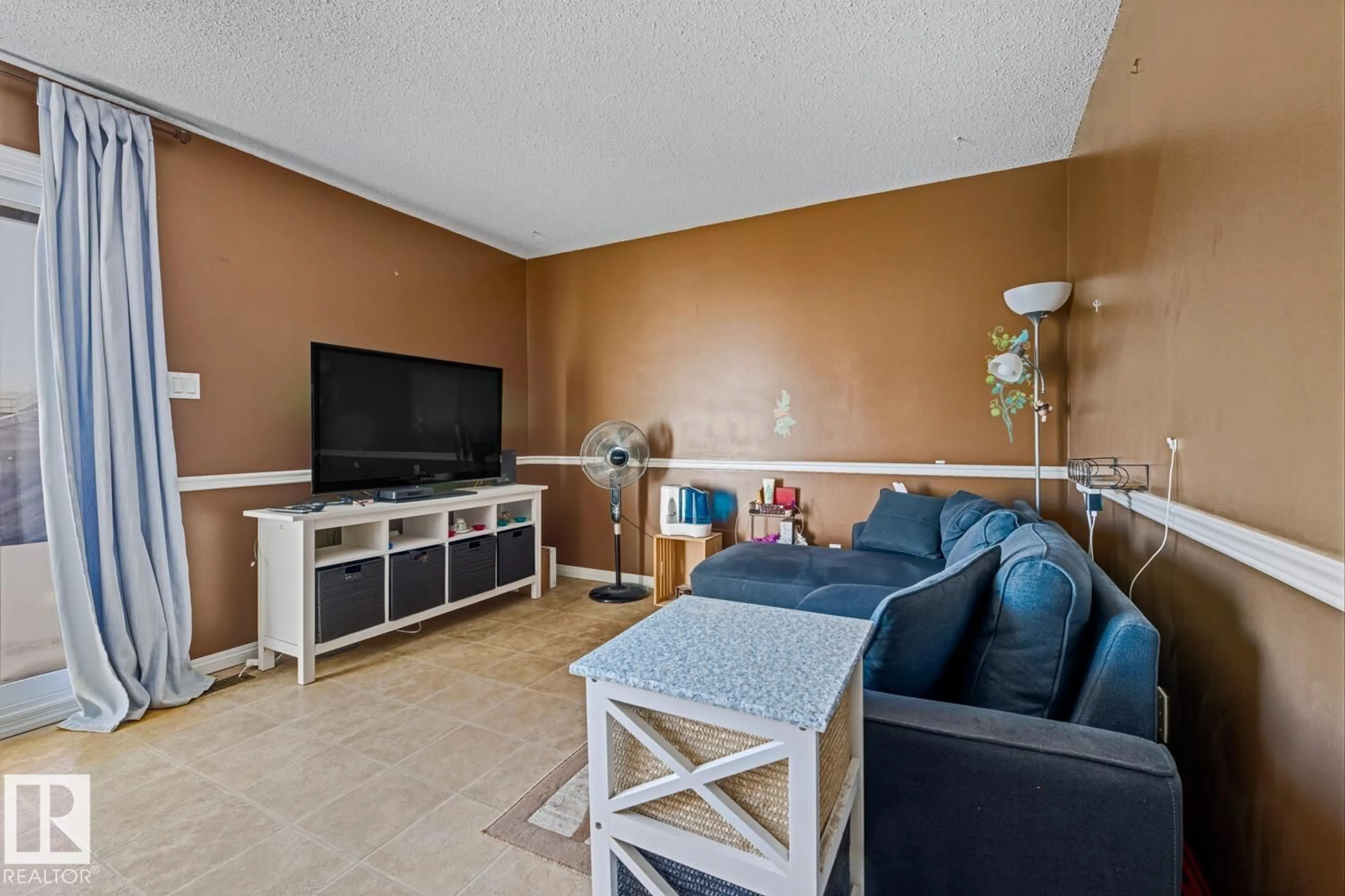Living room with furniture, ceramic/tile floor for 18307 66 AV, Edmonton Alberta T5T1Z5