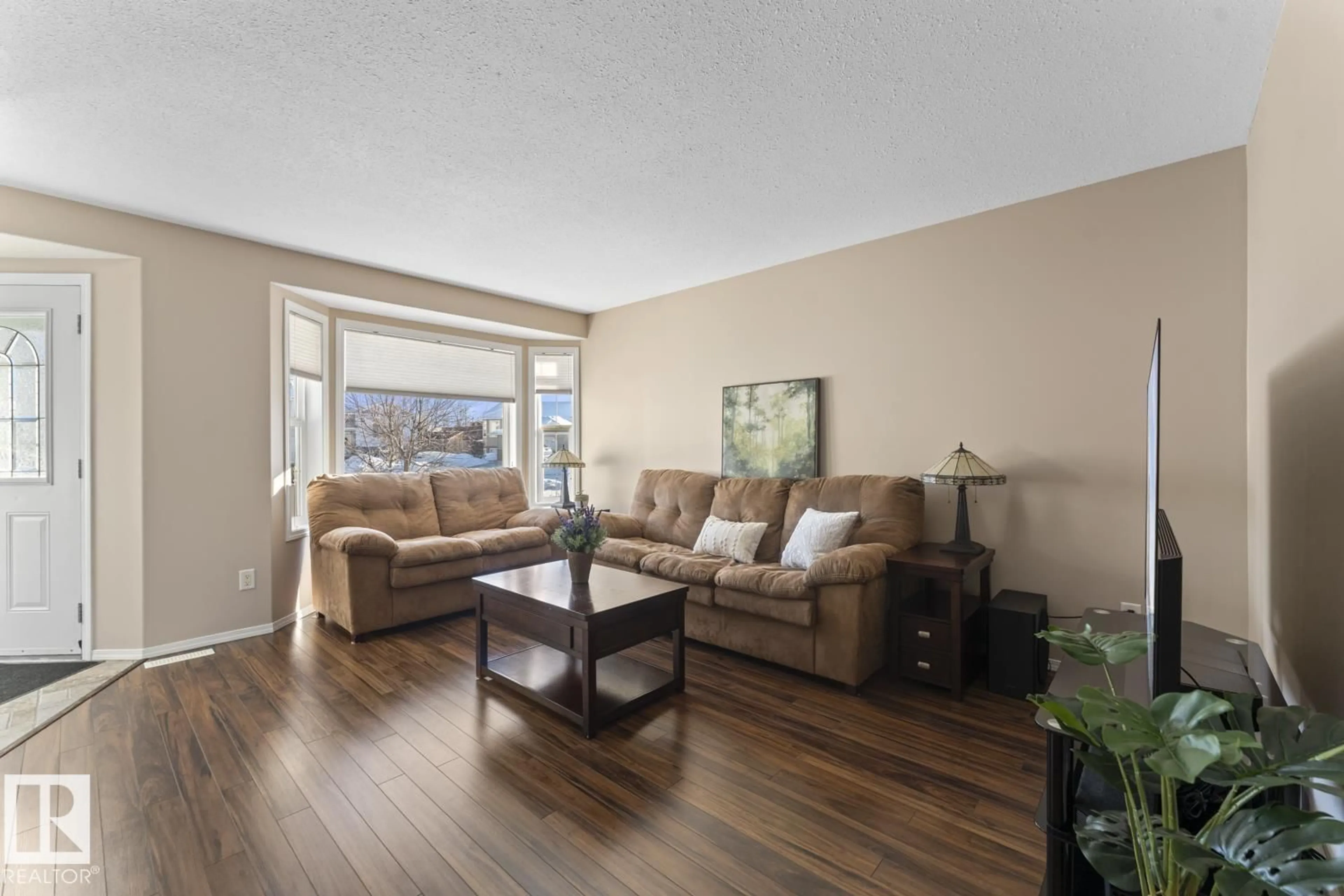Living room with furniture, wood/laminate floor for 705 ROBIN CL, Cold Lake Alberta T9M1W6