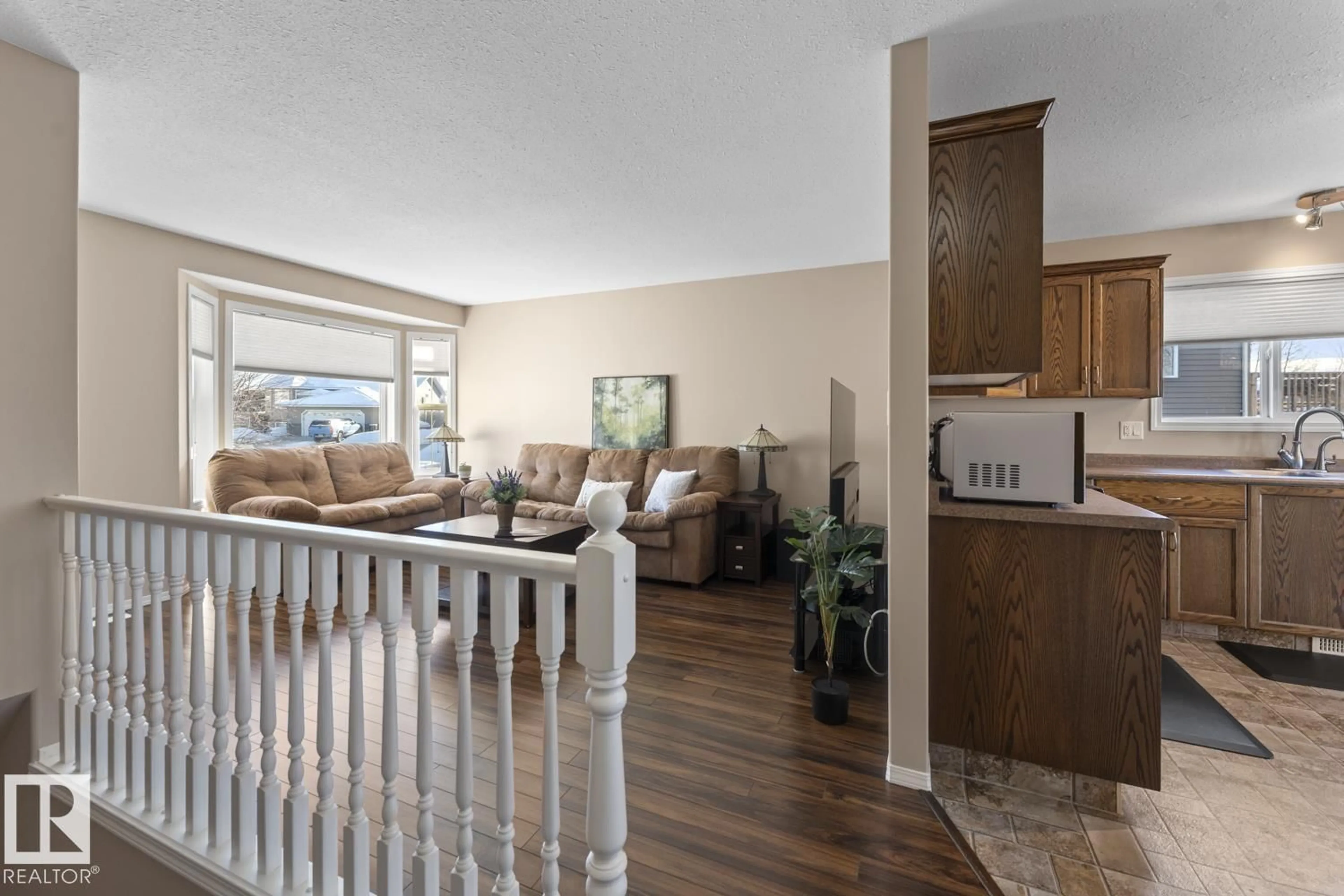 Living room with furniture, wood/laminate floor for 705 ROBIN CL, Cold Lake Alberta T9M1W6