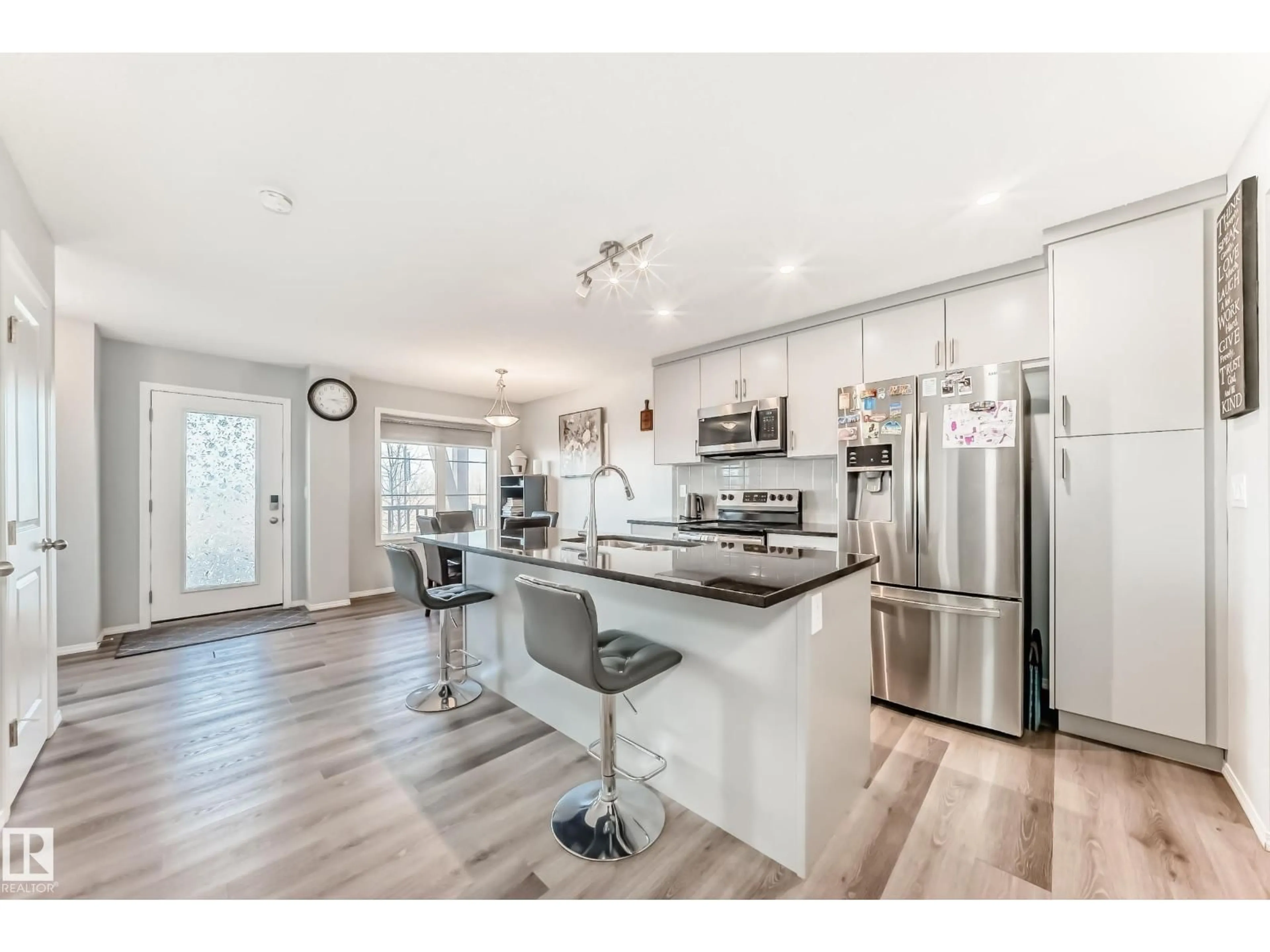 Open concept kitchen, wood/laminate floor for 1002 STILLWATER BV, Edmonton Alberta T6M1M8